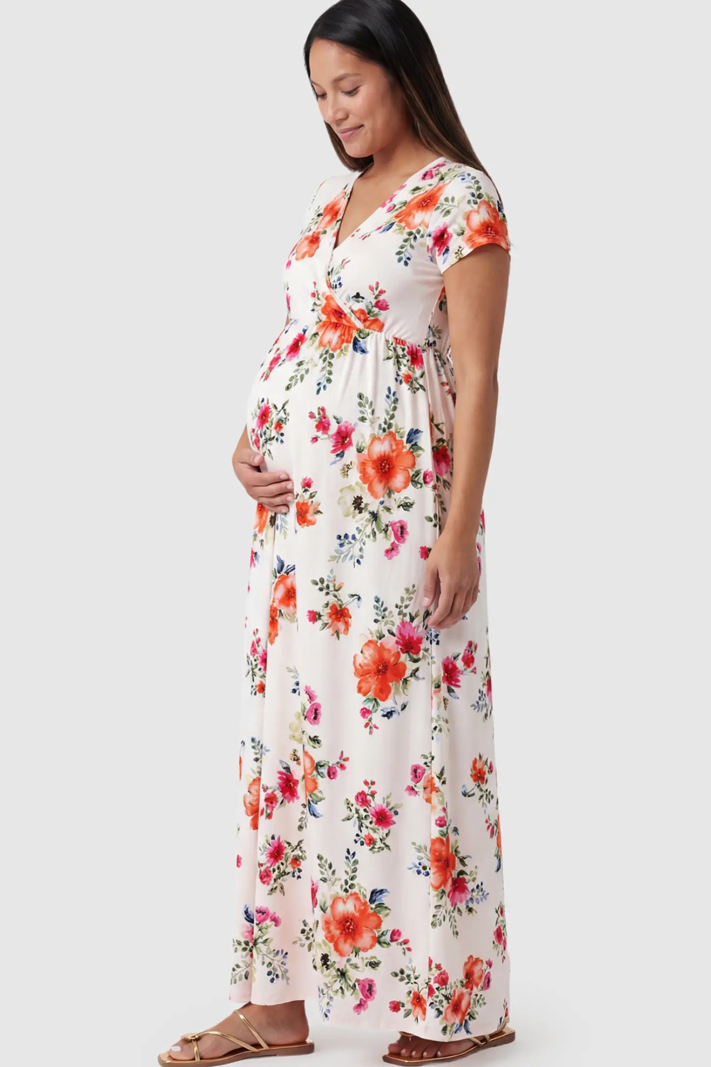 Floral Print V-Neck Maternity Maxi Dress Floral Print V-Neck Maternity Maxi Dress in White featuring a vibrant floral pattern on a pregnant model.