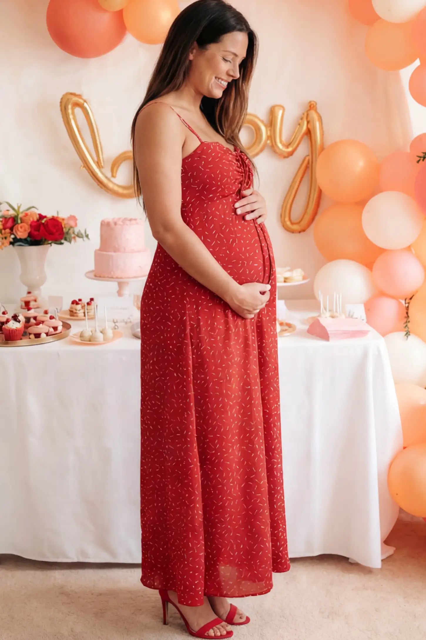 Floral Sweetheart Neck Pleated Midi Maternity Dress in Red Ditsy Floral featuring a delicate chiffon drape on a pregnant model.
