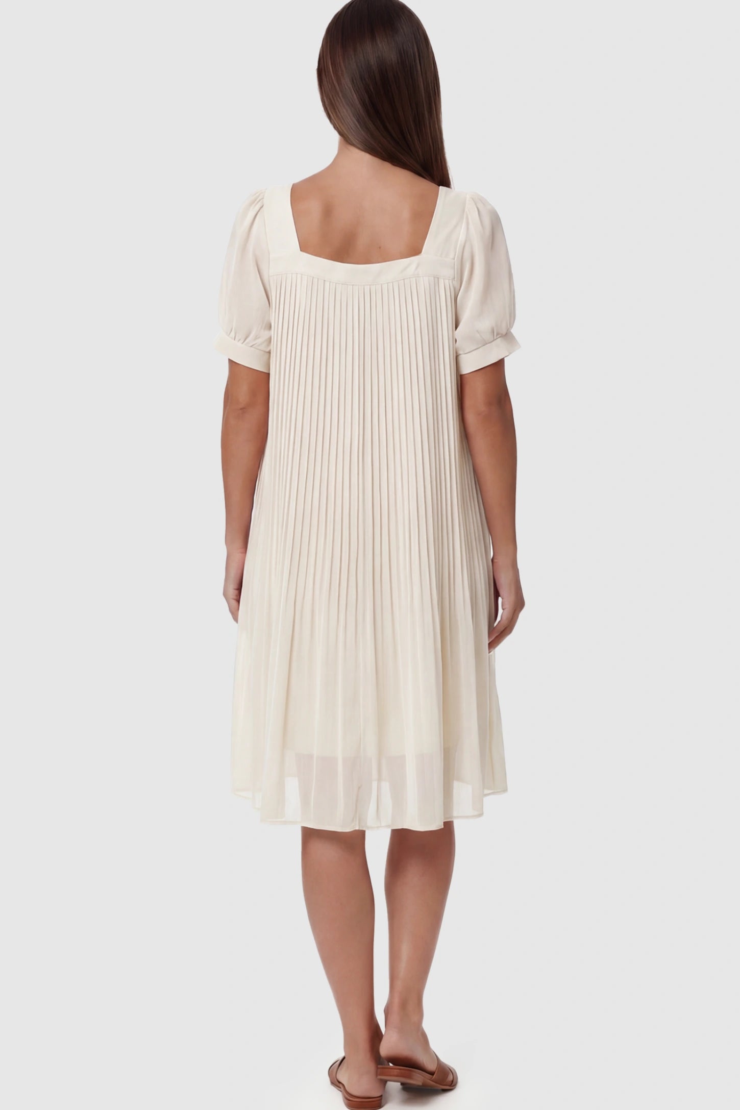 Pleated Front Square Neck Maternity Dress Pleated Front Square Neck Maternity Dress in Off White featuring accordion pleats and short sleeves on a pregnant model.