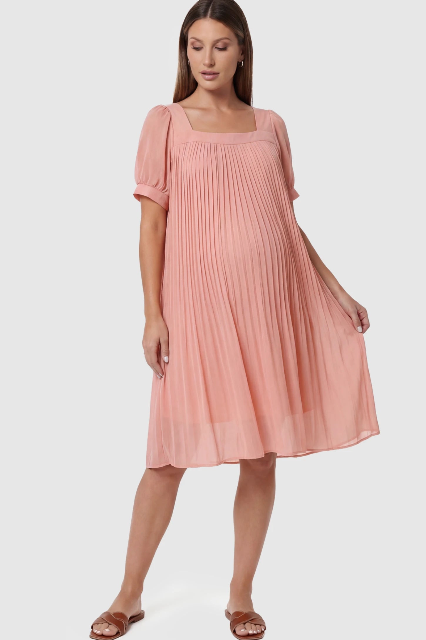 Pleated Front Square Neck Maternity Dress in Pink featuring accordion pleats and short sleeves on a pregnant model.