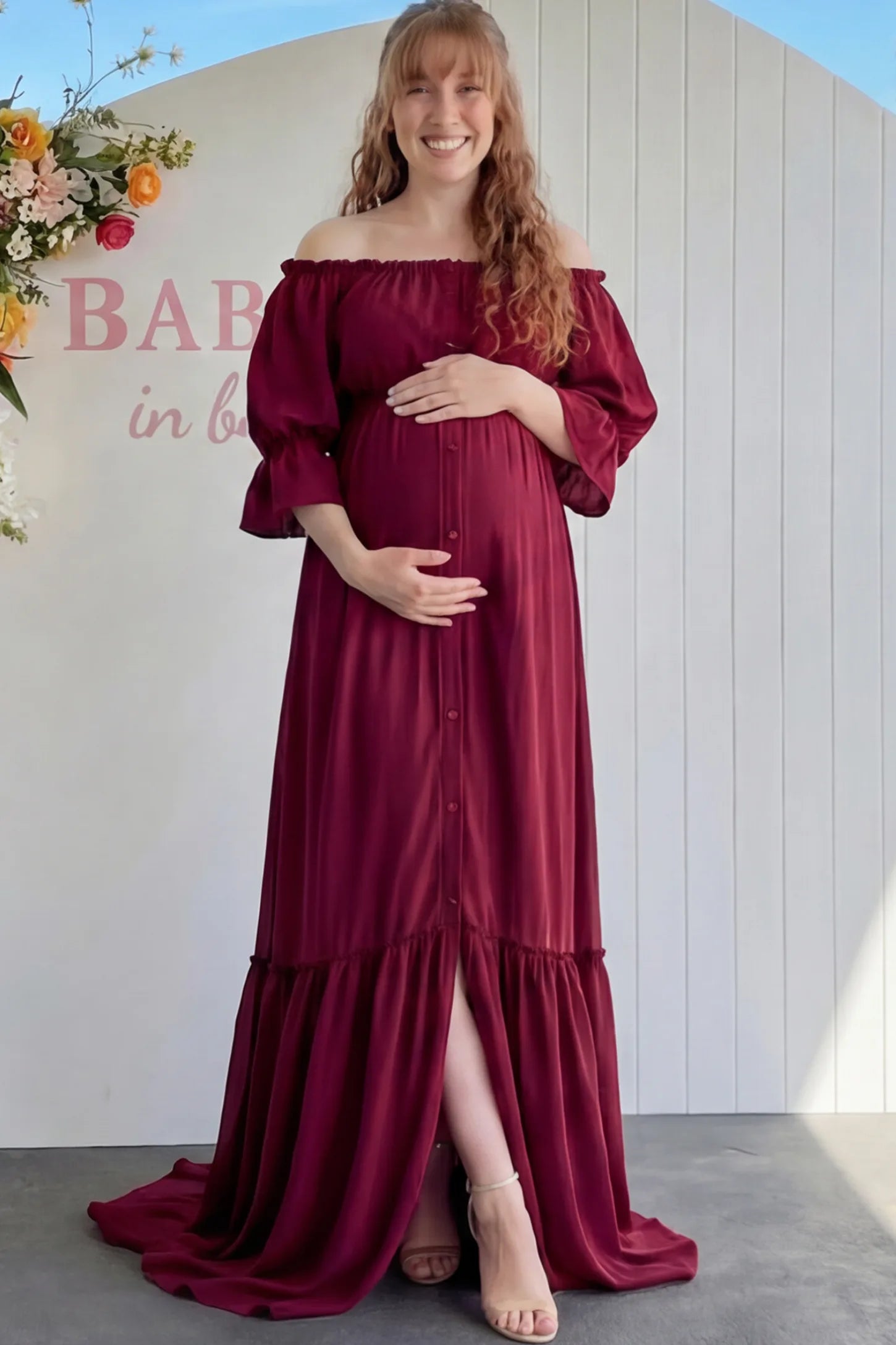 Linen-Blend Button Down Off Shoulder Maternity Maxi Dress Linen-Blend Off-the-Shoulder Maternity Maxi Dress in Wine Red featuring a button-down front on a pregnant model.