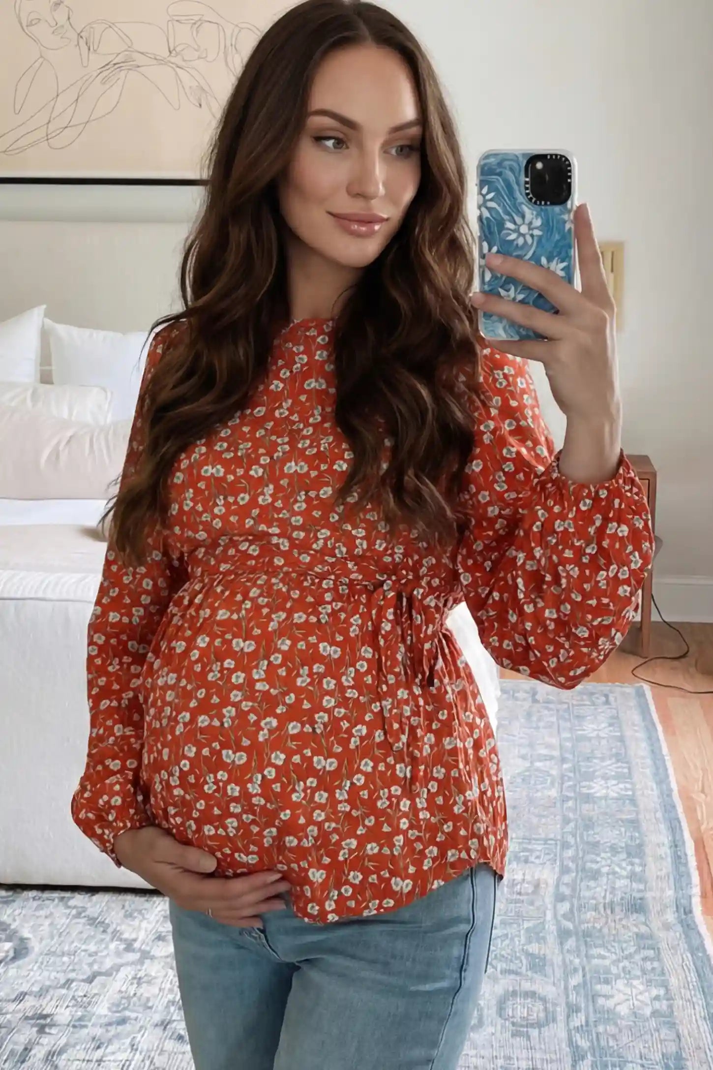 Floral Round Neck Babydoll Maternity Top Floral Round Neck Babydoll Maternity Top in Red featuring an adjustable waist tie on a pregnant model.