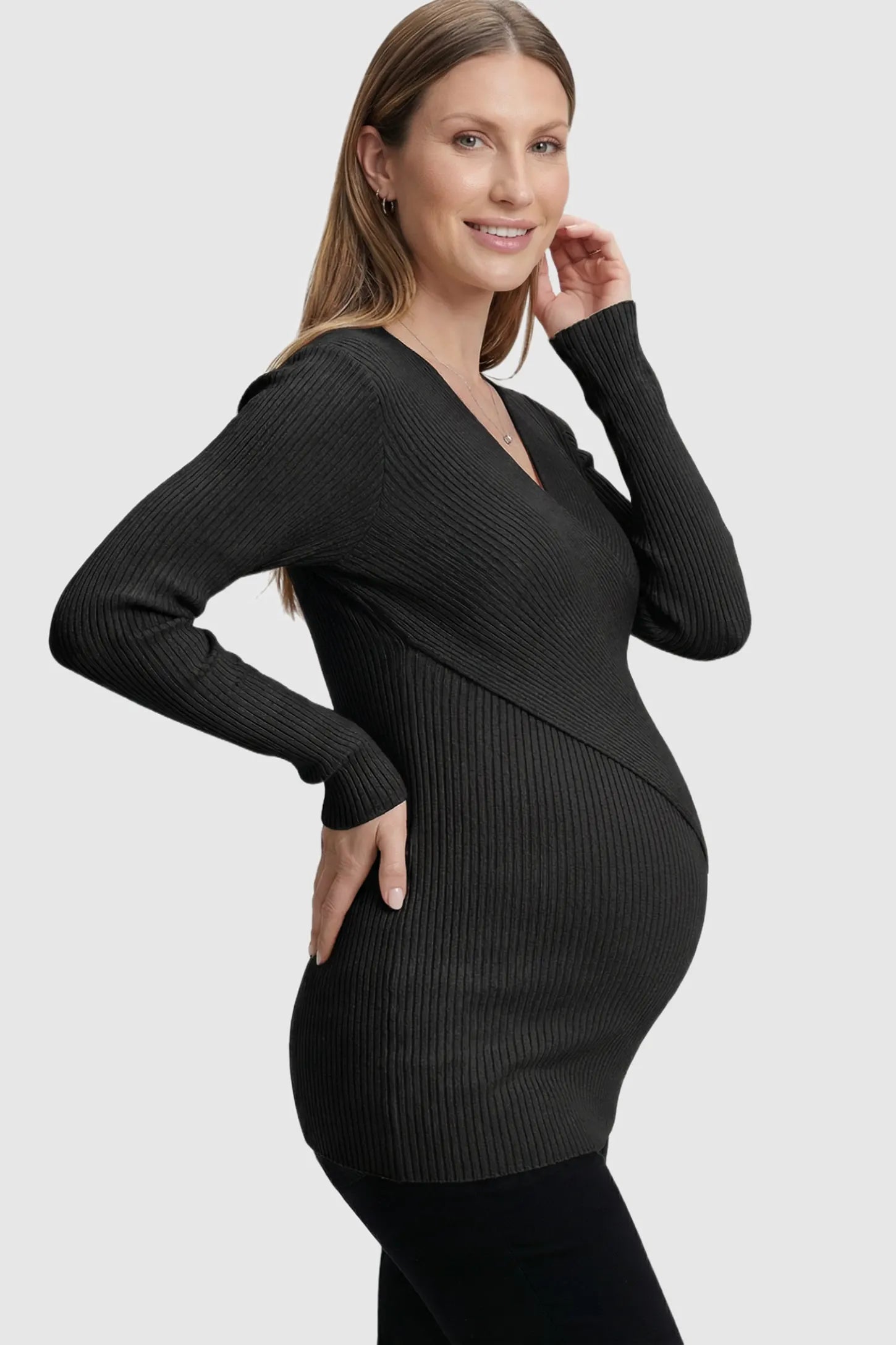 Cross-Over Ribbed Knit Maternity & Nursing Top Cross-Over Ribbed Knit Maternity & Nursing Top in Black featuring a wrap neckline and textured finish on a pregnant model.