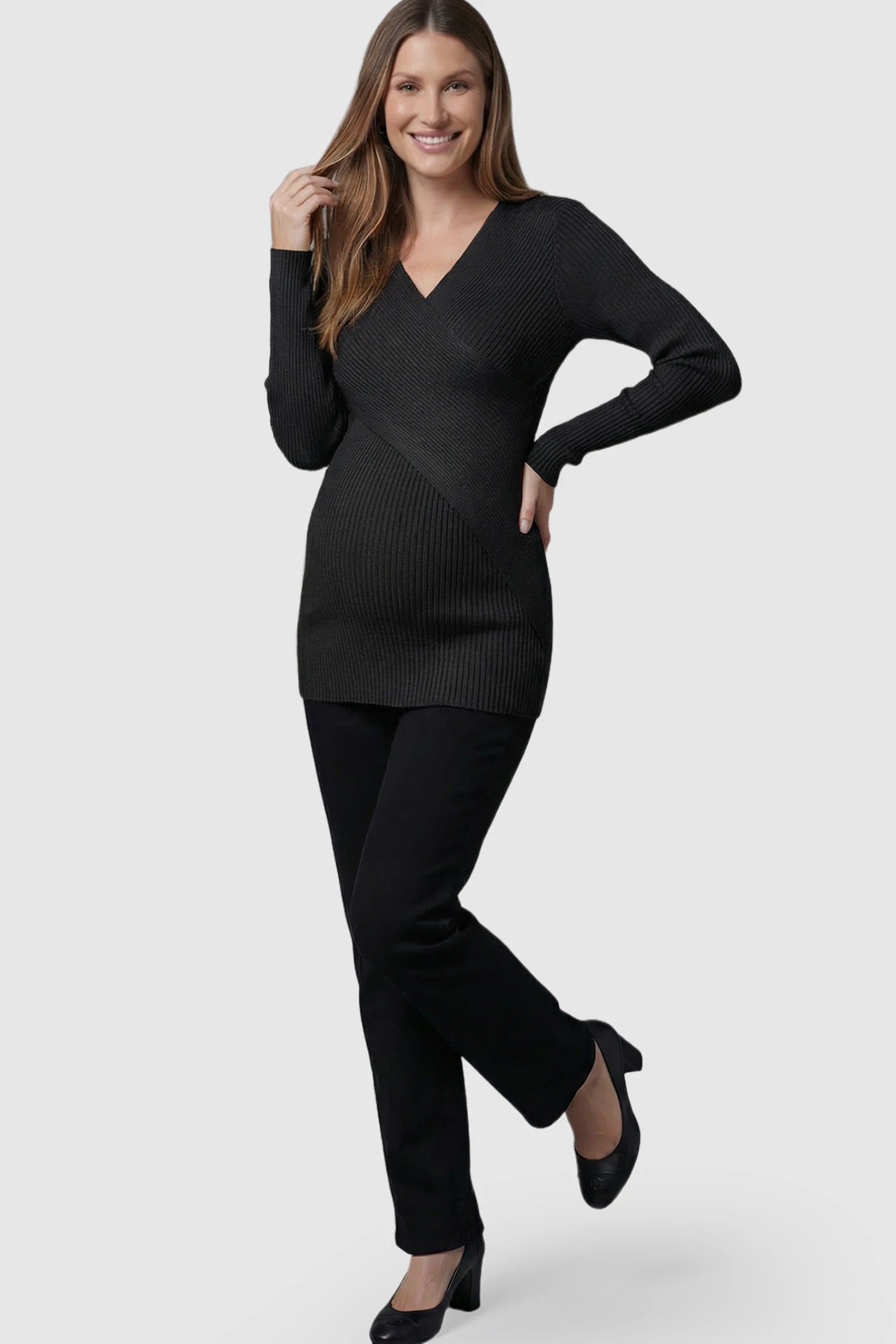 Cross-Over Ribbed Knit Maternity & Nursing Top Cross-Over Ribbed Knit Maternity & Nursing Top in Black featuring a wrap neckline and textured finish on a pregnant model.