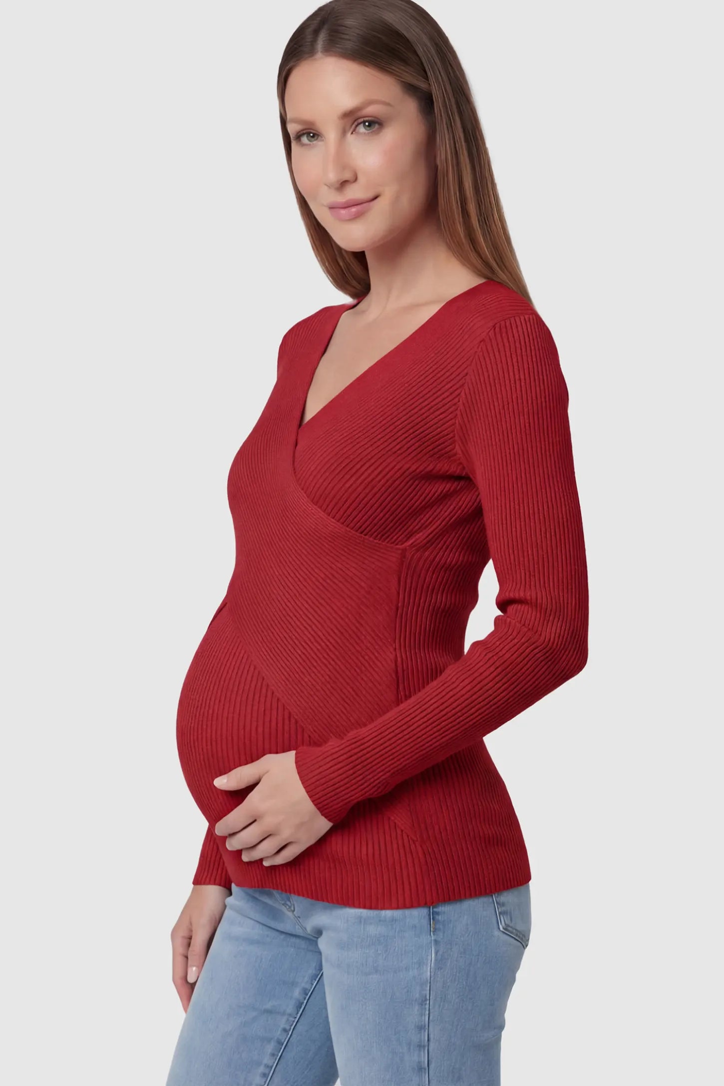 Cross-Over Ribbed Knit Maternity & Nursing Top Cross-Over Ribbed Knit Maternity & Nursing Top in Red featuring a wrap neckline and textured finish on a pregnant model.