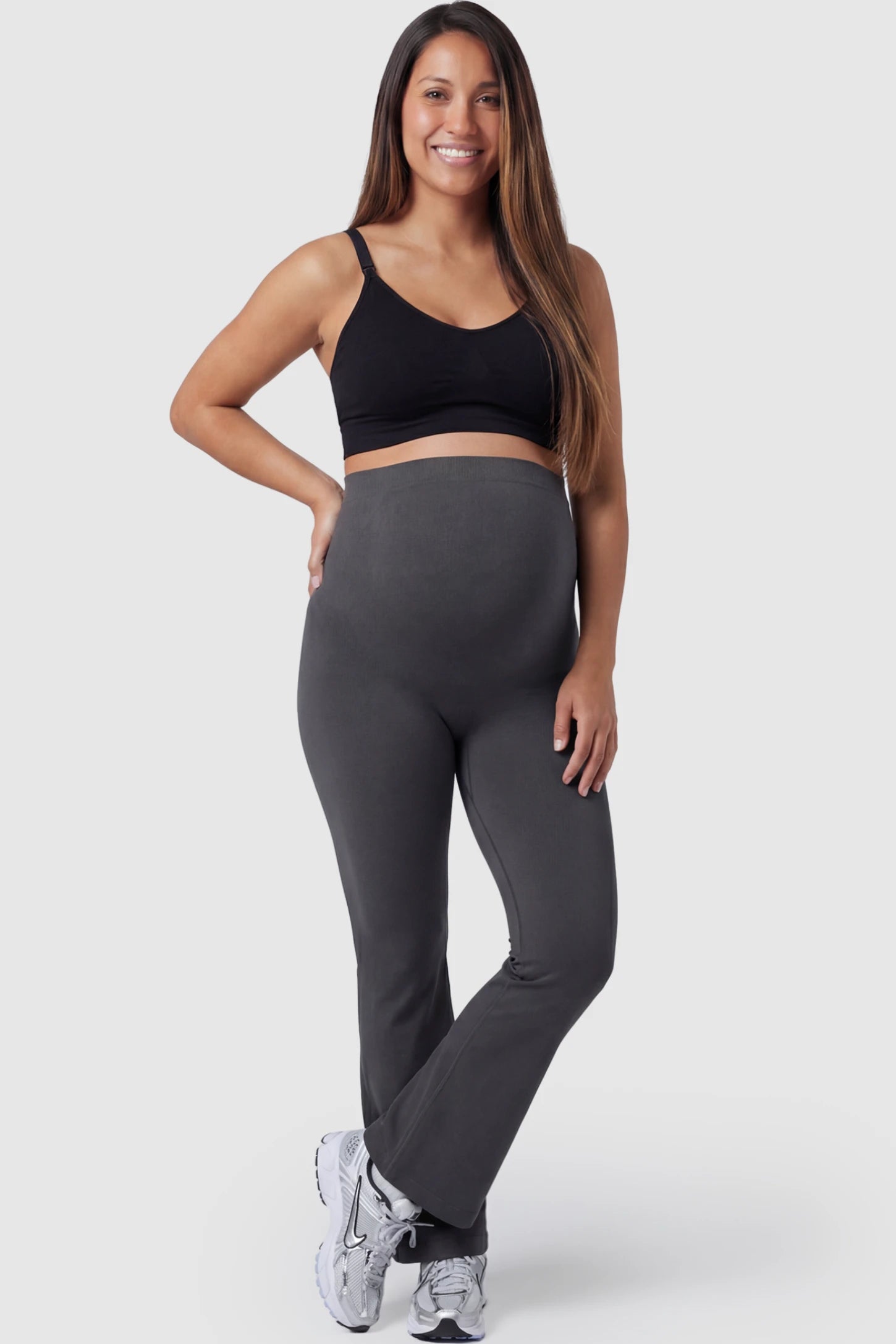 High Waisted Flare Leg Maternity Pants in gray featuring a flexible over-the-belly support band on a pregnant model.