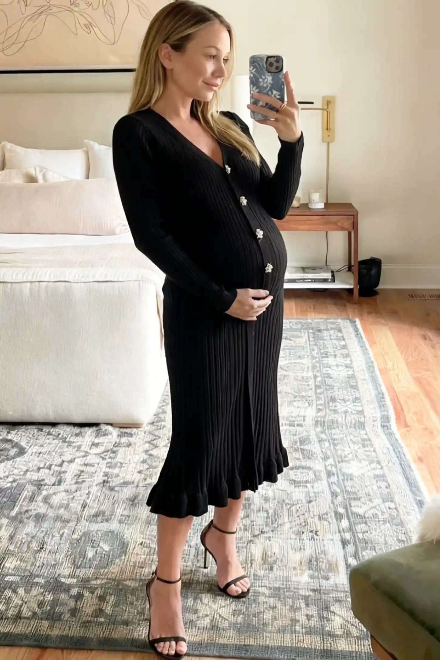Ribbed V-Neck Maternity Midi Sweater Dress Ribbed V-Neck Maternity Midi Sweater Dress in Black featuring rhinestone buttons on a pregnant model.