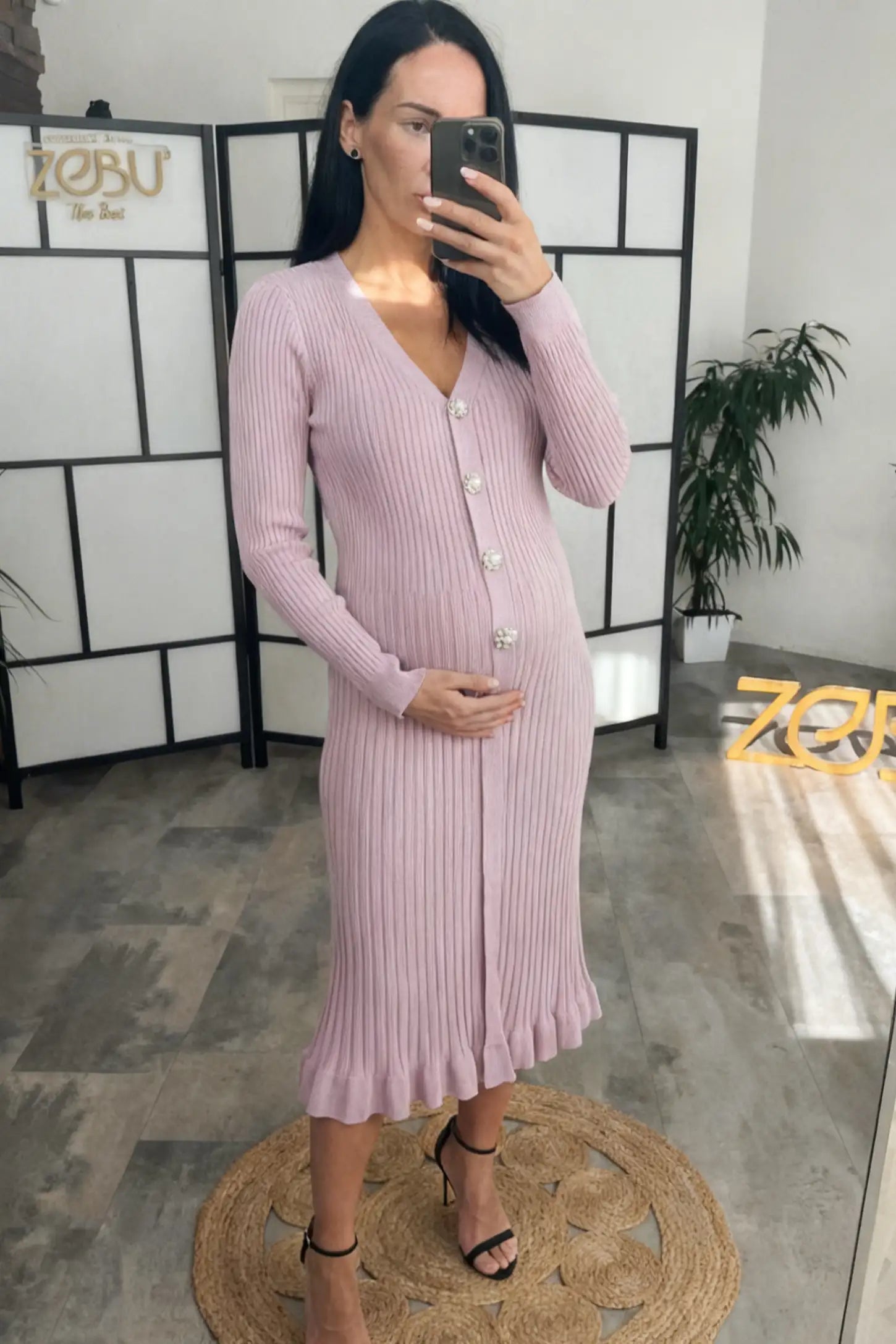 Ribbed V-Neck Maternity Midi Sweater Dress Ribbed V-Neck Maternity Midi Sweater Dress in Pink featuring rhinestone buttons on a pregnant model.