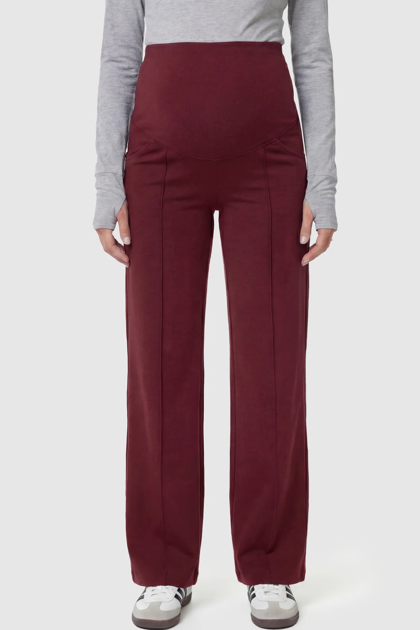High-Stretch Wide Leg Pocketed Maternity Pants in Burgundy featuring a seamless over-the-bump panel and side pocket on a pregnant model.