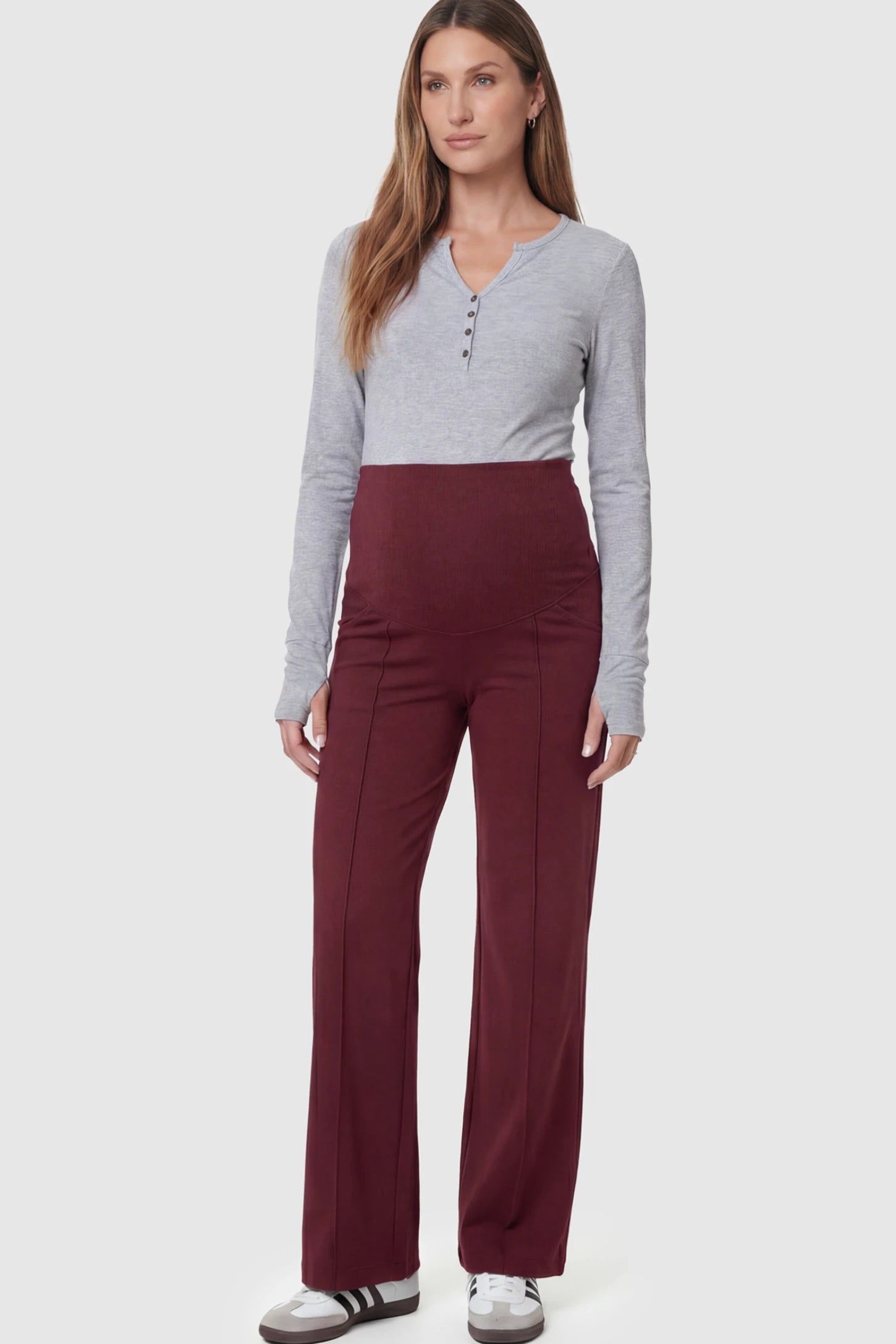 High-Stretch Wide Leg Pocketed Maternity Pants in Burgundy featuring a seamless over-the-bump panel and side pocket on a pregnant model.