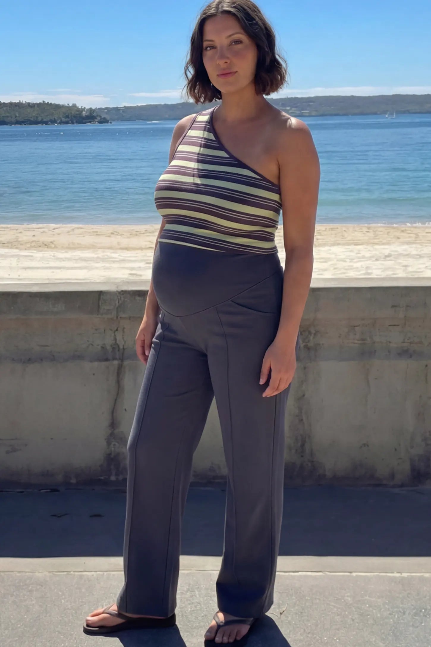 High Stretch Wide Leg Pocketed Maternity Pants High-Stretch Wide Leg Pocketed Maternity Pants in Dark gray featuring a seamless over-the-bump panel and side pocket on a pregnant model.