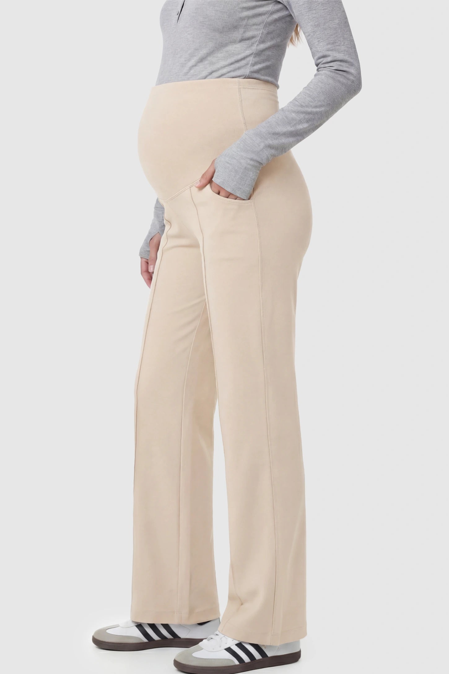 High Stretch Wide Leg Pocketed Maternity Pants High-Stretch Wide Leg Pocketed Maternity Pants in Off White featuring a seamless over-the-bump panel and side pockets on a pregnant model.