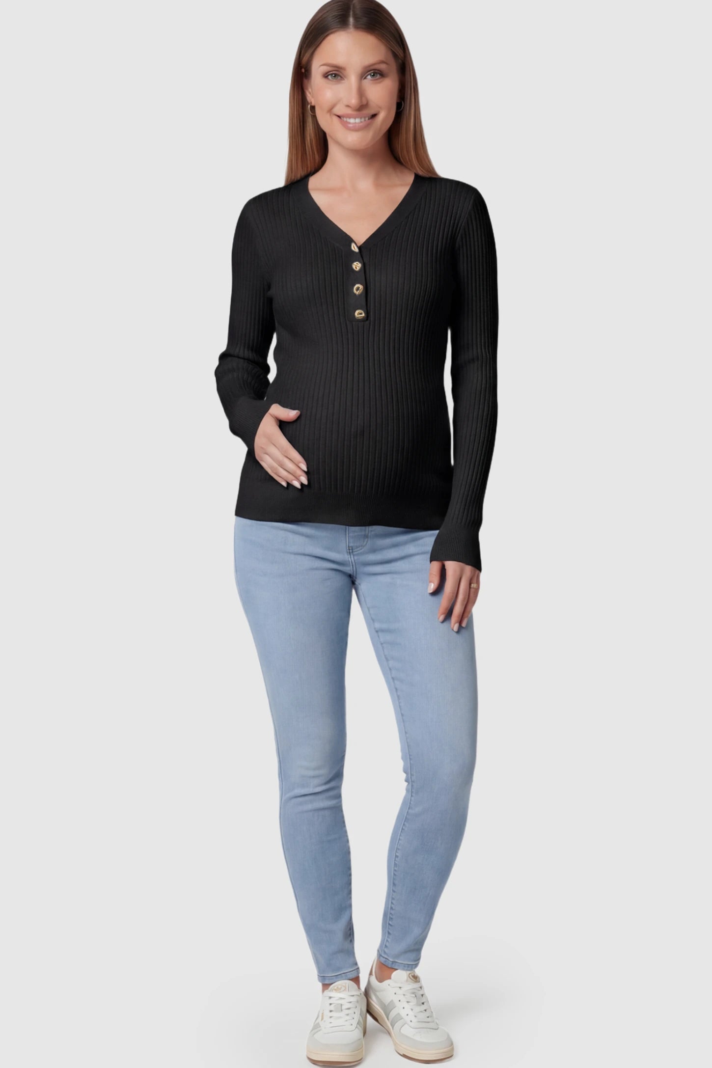 Ribbed Long Sleeve Maternity Henley Top Ribbed Maternity Henley Top in Black featuring a functional button placket and vertical rib knit on a pregnant model.