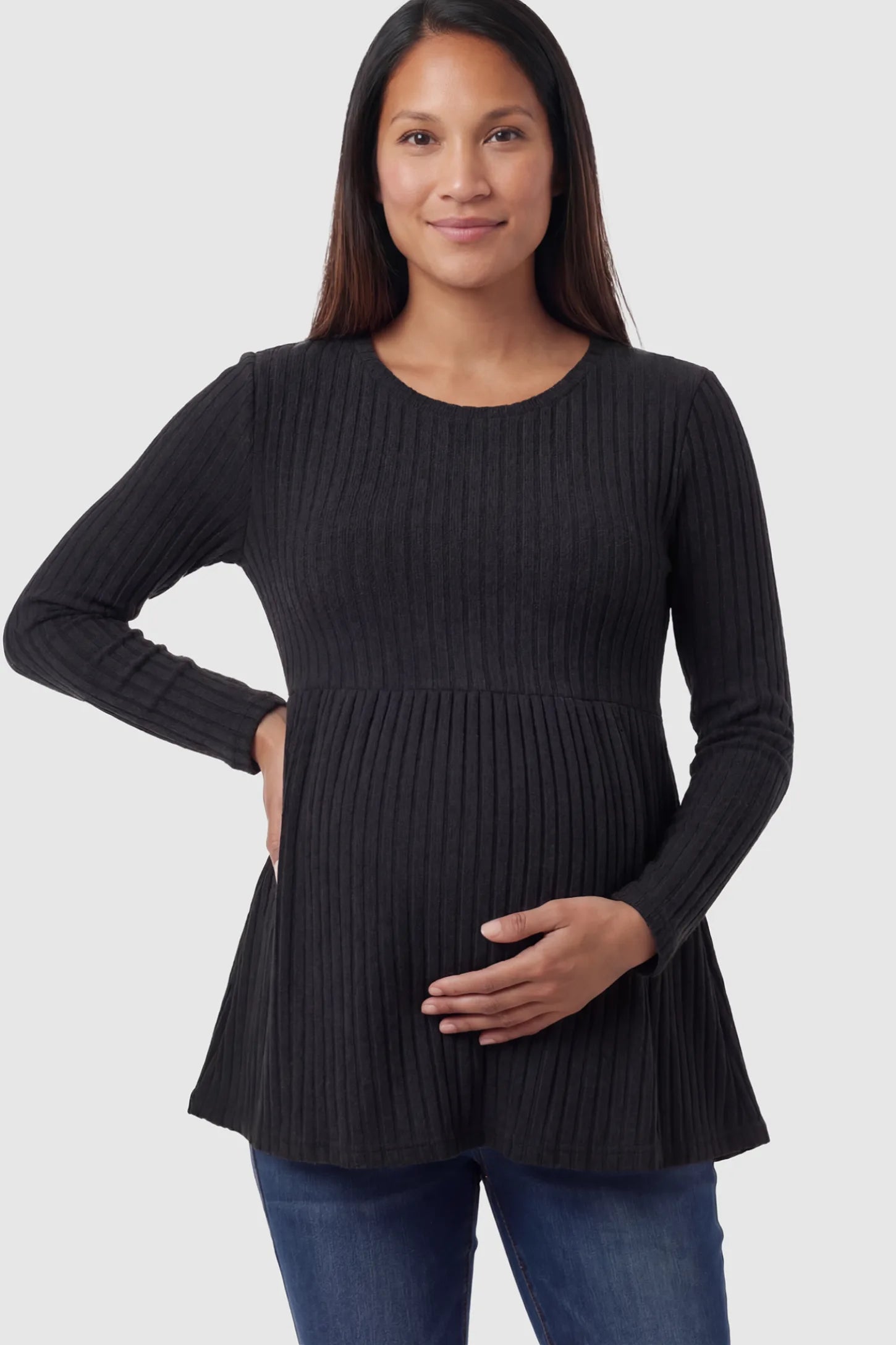 Ribbed Knit Long Sleeve Maternity Top Ribbed Knit Long Sleeve Maternity Top in black featuring an empire waist and high-stretch fabric on a pregnant model.