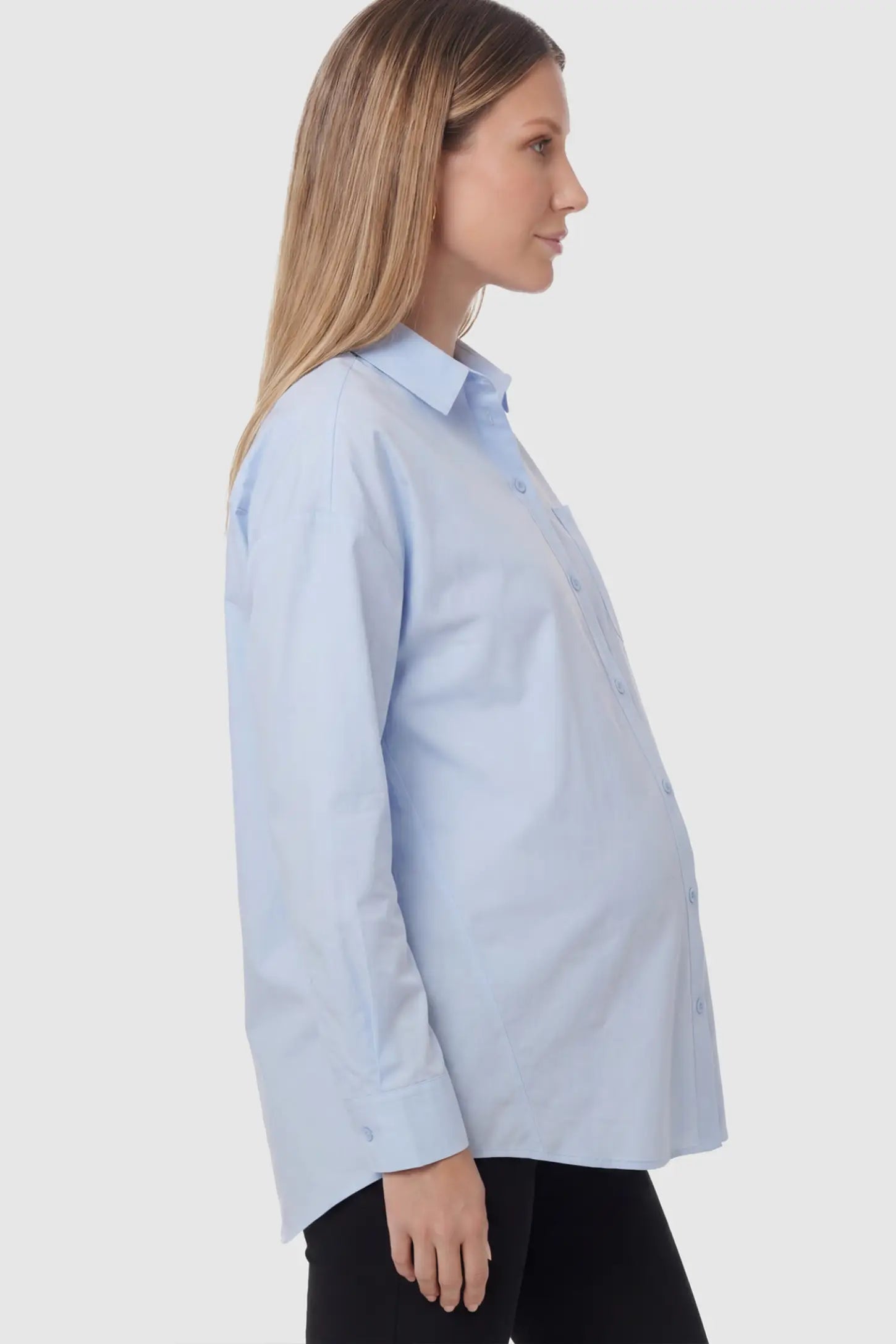 Button Down Collared Maternity Shirt in Light Blue featuring long sleeves and a crisp cotton finish on a pregnant model.