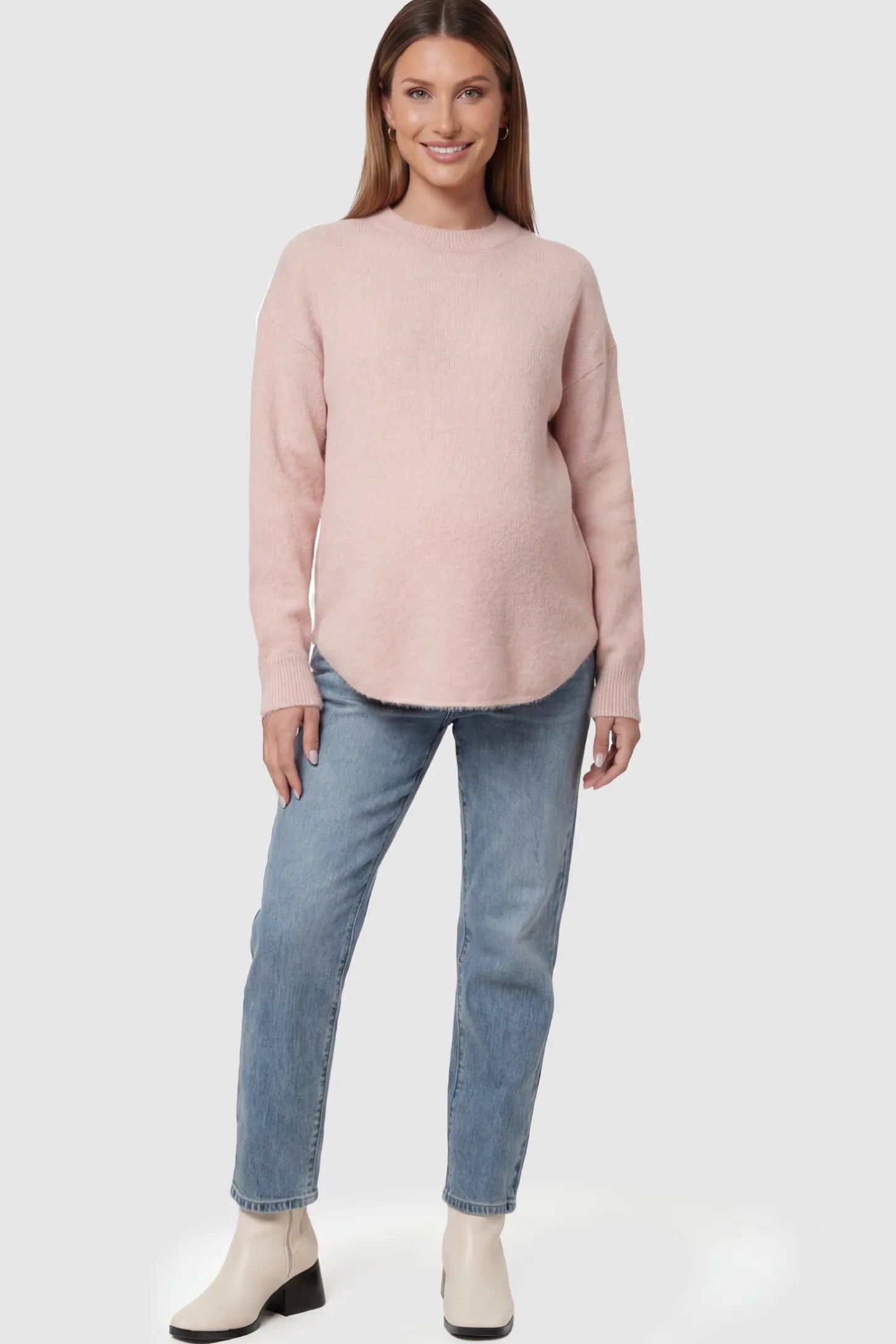 Mock Neck Long Sleeve Maternity Sweater Mock Neck Long Sleeve Maternity Sweater in Pink thickened woolen fabric on a pregnant model.