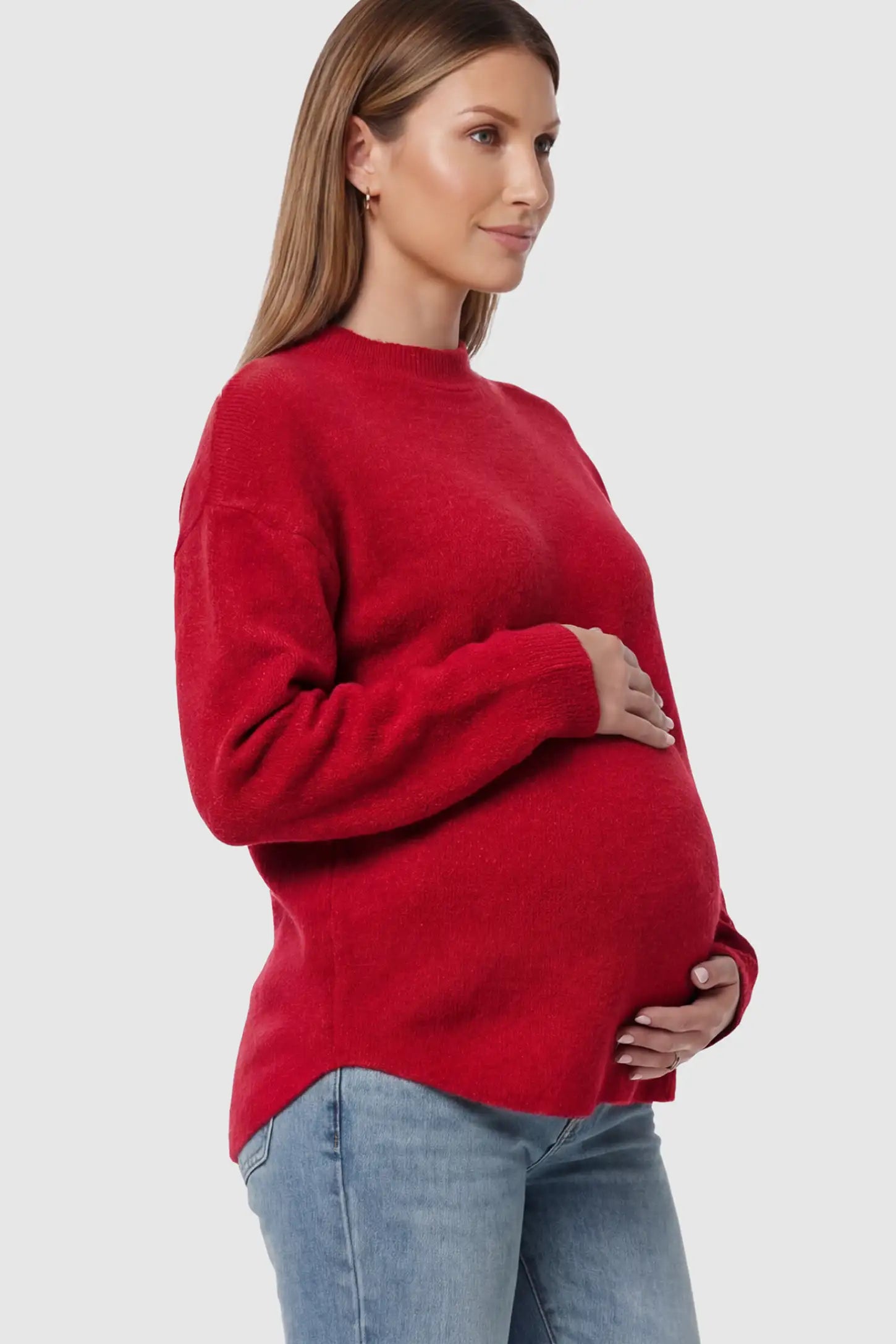 Mock Neck Long Sleeve Maternity Sweater Mock Neck Long Sleeve Maternity Sweater in Red thickened woolen fabric on a pregnant model.