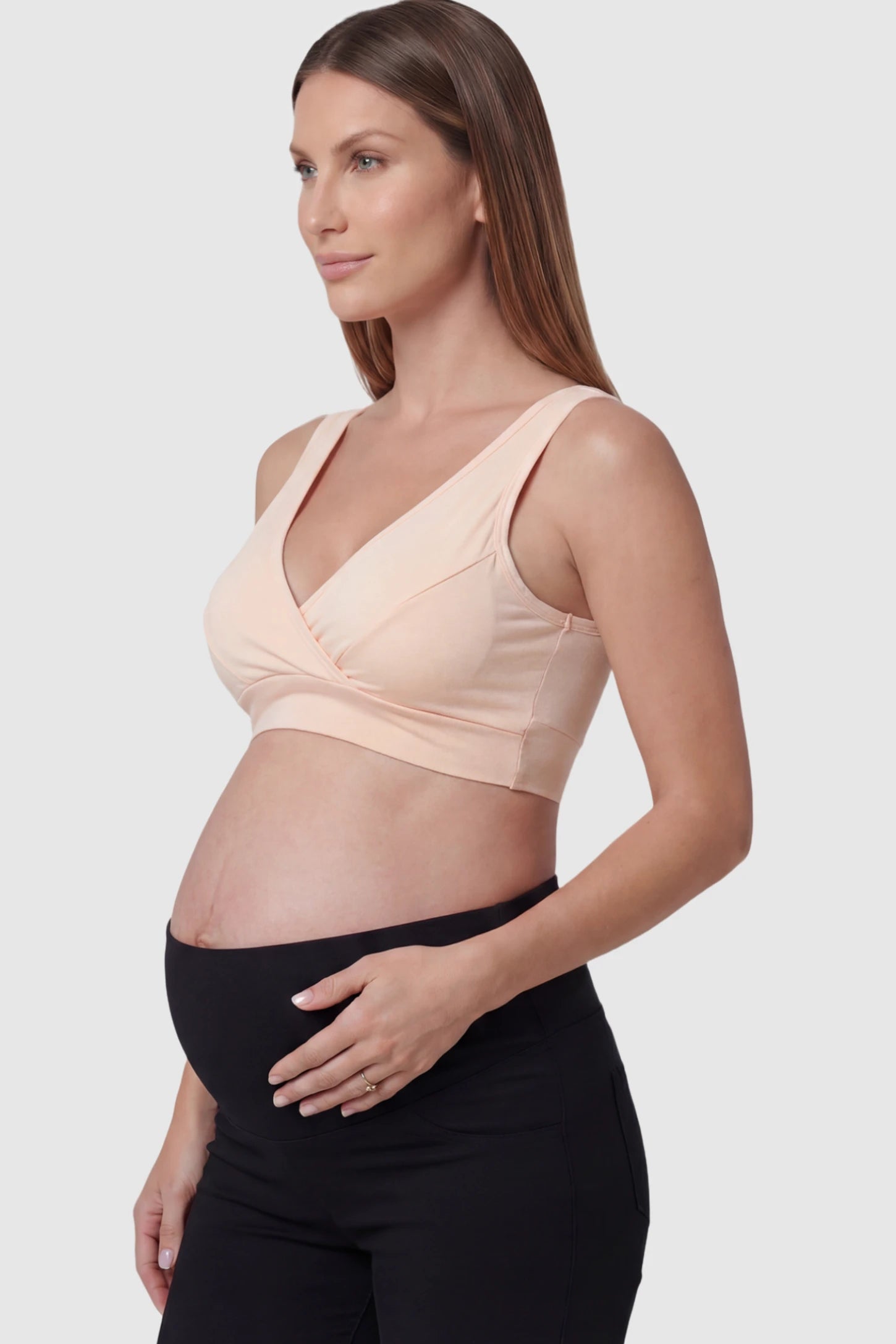 Soft Cotton Crossover Wireless Maternity Nursing Bra Soft Cotton Crossover Wireless Pull-On Maternity Nursing Bra in Shrimp Color featuring a wrap-front design on a pregnant model.