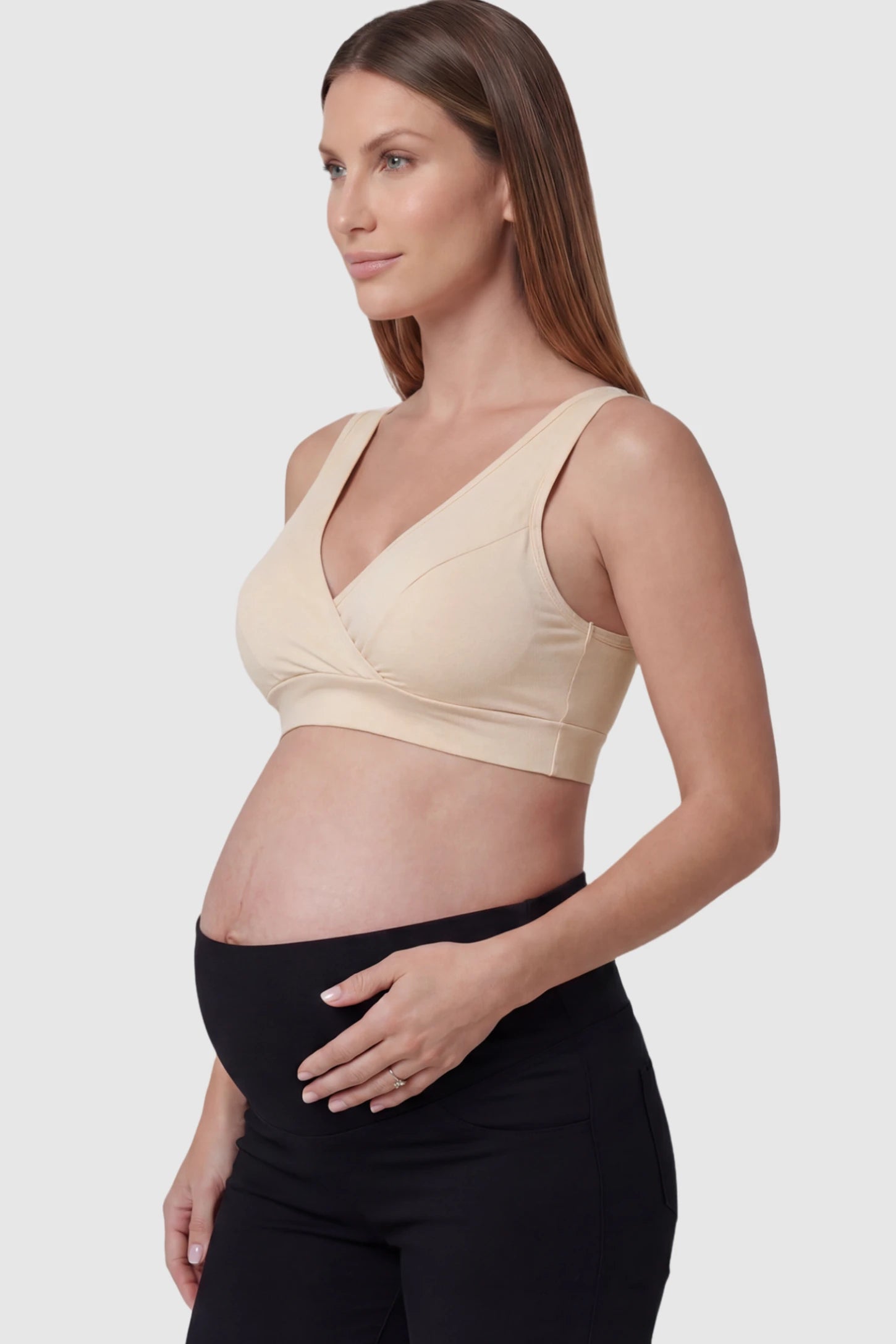 Soft Cotton Crossover Wireless Maternity Nursing Bra Soft Cotton Crossover Wireless Pull-On Maternity Nursing Bra in Skin Color featuring a wrap-front design on a pregnant model.