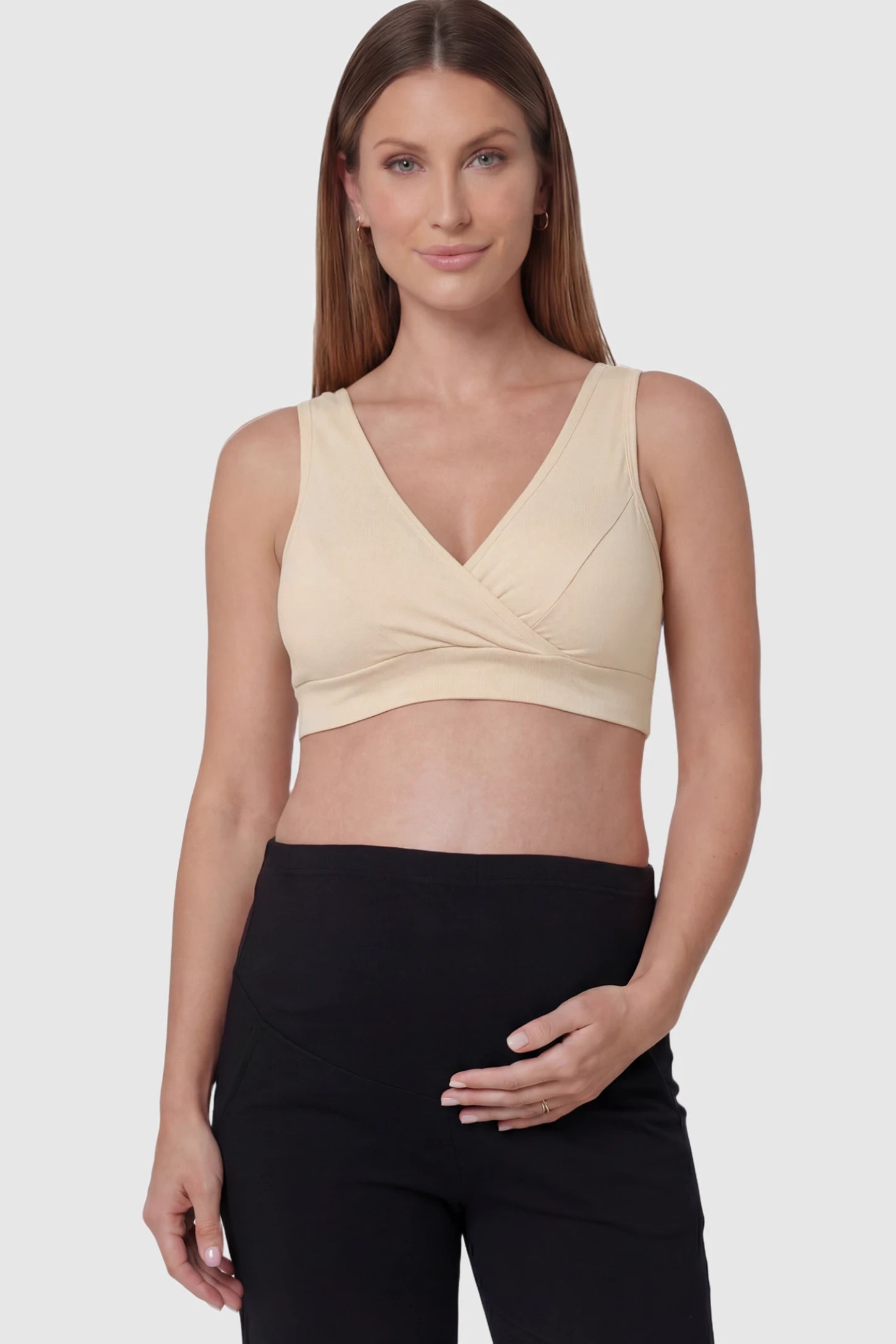 Soft Cotton Crossover Wireless Maternity Nursing Bra Soft Cotton Crossover Wireless Pull-On Maternity Nursing Bra in Skin Color featuring a wrap-front design on a pregnant model.