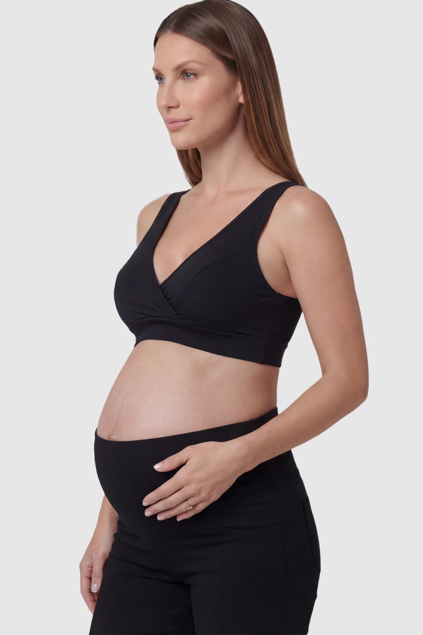Soft Cotton Crossover Wireless Maternity Nursing Bra Soft Cotton Crossover Wireless Pull-On Maternity Nursing Bra in Black featuring a wrap-front design on a pregnant model.