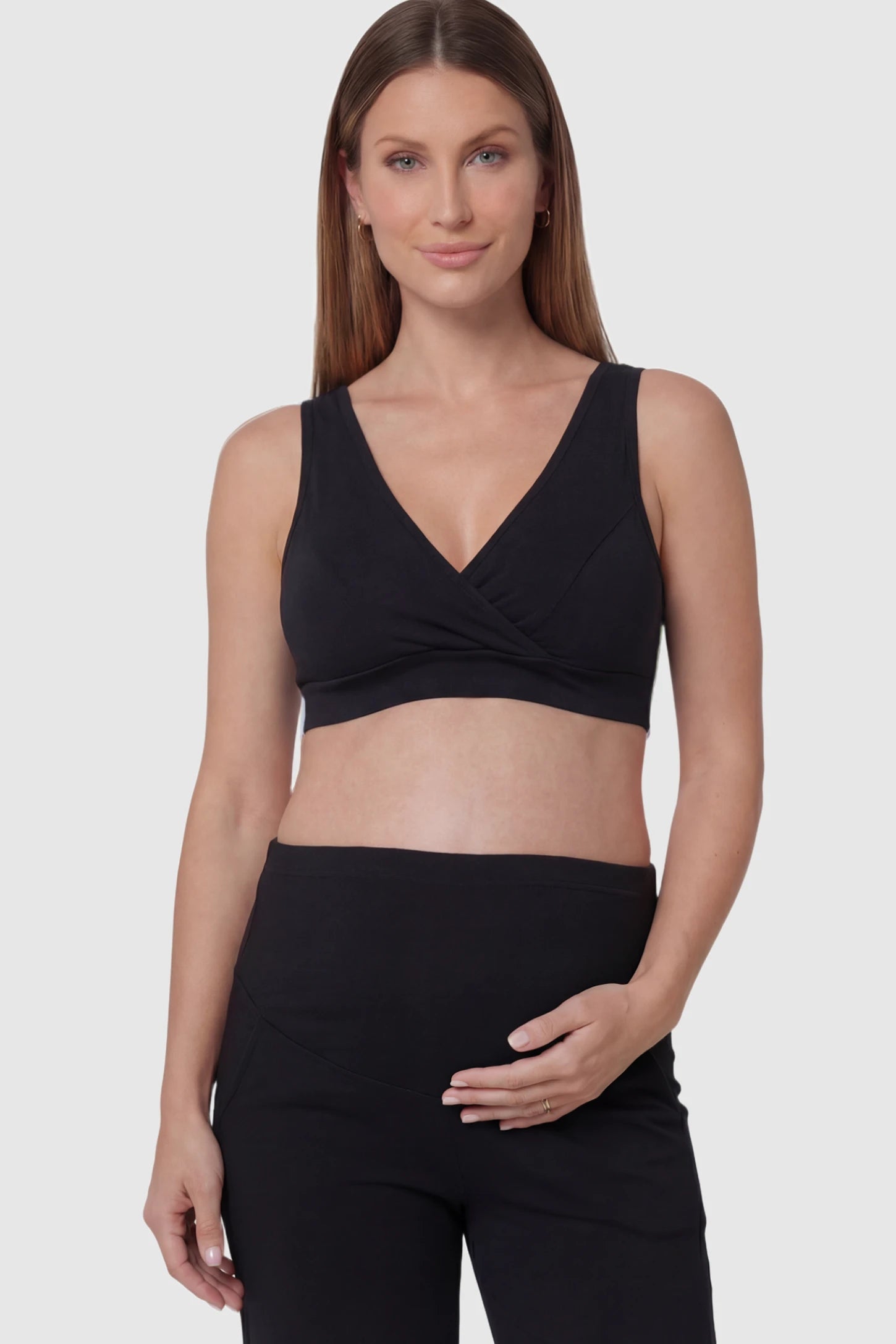 Soft Cotton Crossover Wireless Maternity Nursing Bra Soft Cotton Crossover Wireless Pull-On Maternity Nursing Bra in Black featuring a wrap-front design on a pregnant model.
