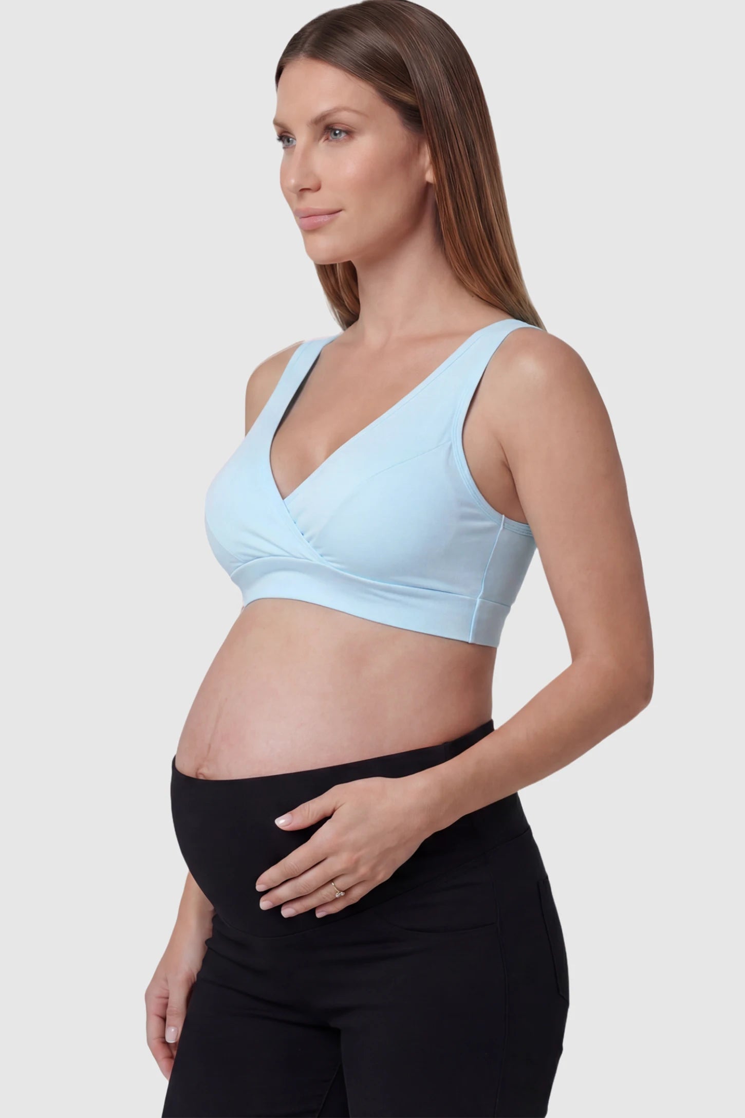 Soft Cotton Crossover Wireless Maternity Nursing Bra Soft Cotton Crossover Wireless Pull-On Maternity Nursing Bra in Blue featuring a wrap-front design on a pregnant model.