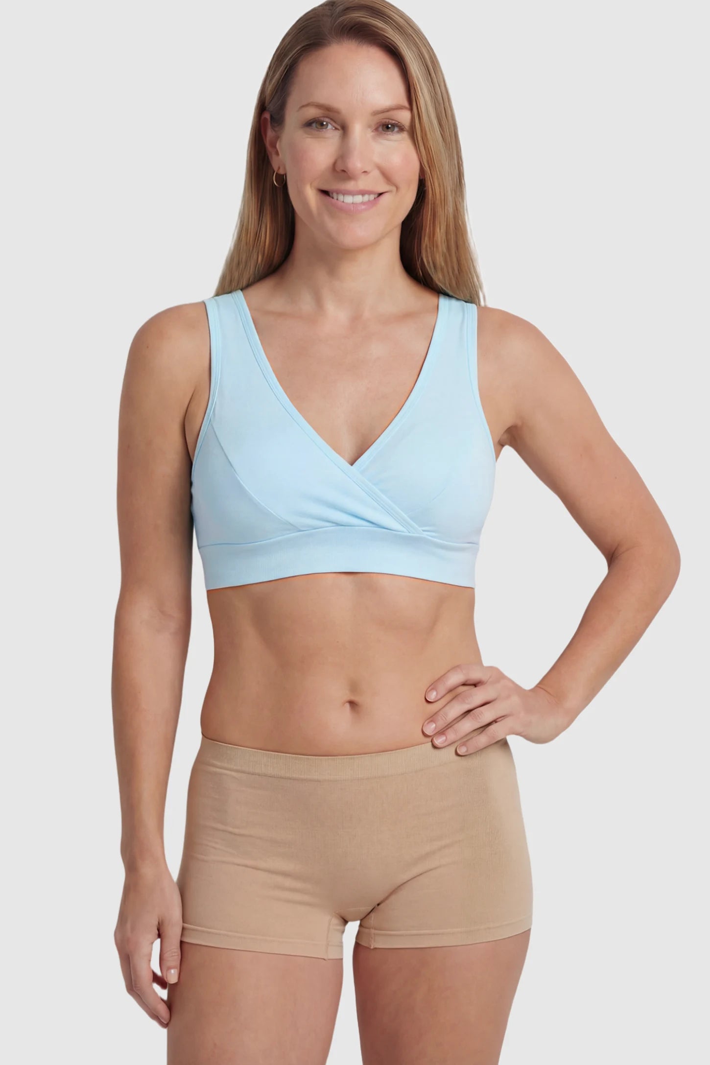 Soft Cotton Crossover Wireless Maternity Nursing Bra Soft Cotton Crossover Wireless Pull-On Maternity Nursing Bra in Blue featuring a wrap-front design on a postpartum model.