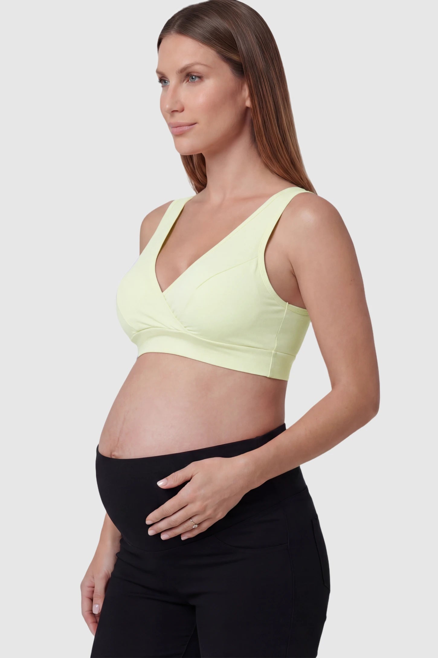 Soft Cotton Crossover Wireless Maternity Nursing Bra Soft Cotton Crossover Wireless Pull-On Maternity Nursing Bra in Green featuring a wrap-front design on a pregnant model.