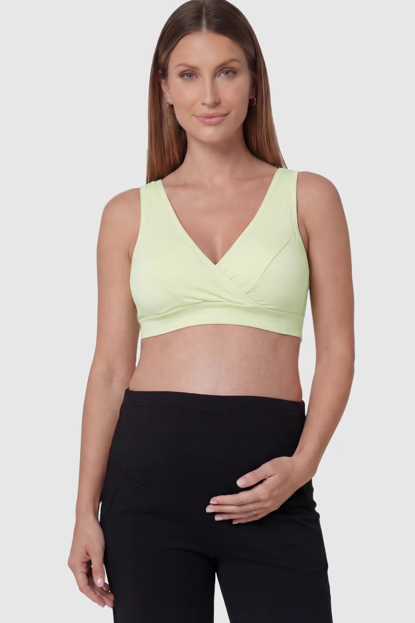 Soft Cotton Crossover Wireless Maternity Nursing Bra Soft Cotton Crossover Wireless Pull-On Maternity Nursing Bra in Green featuring a wrap-front design on a pregnant model.
