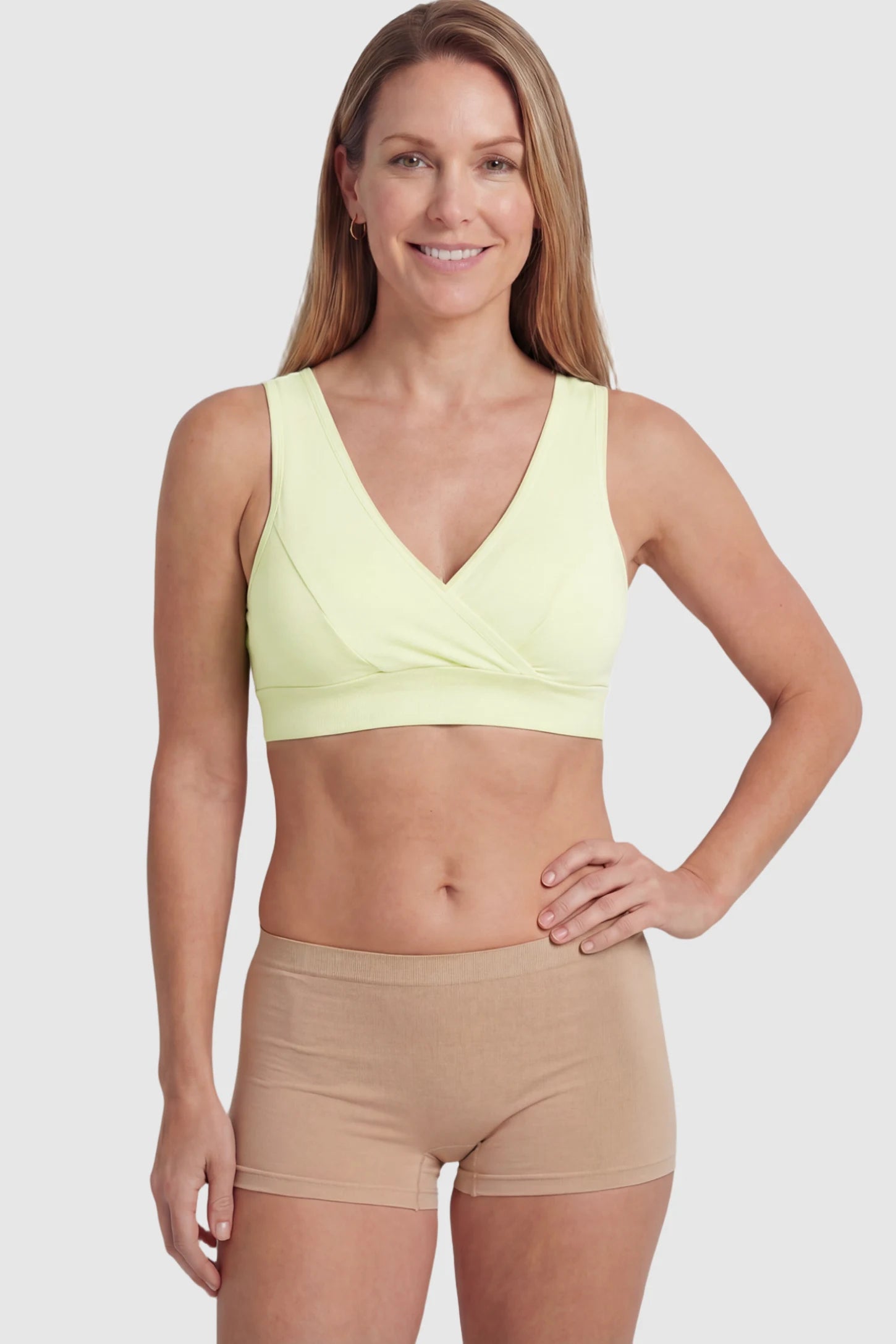 Soft Cotton Crossover Wireless Maternity Nursing Bra Soft Cotton Crossover Wireless Pull-On Maternity Nursing Bra in Green featuring a wrap-front design on a postpartum model.