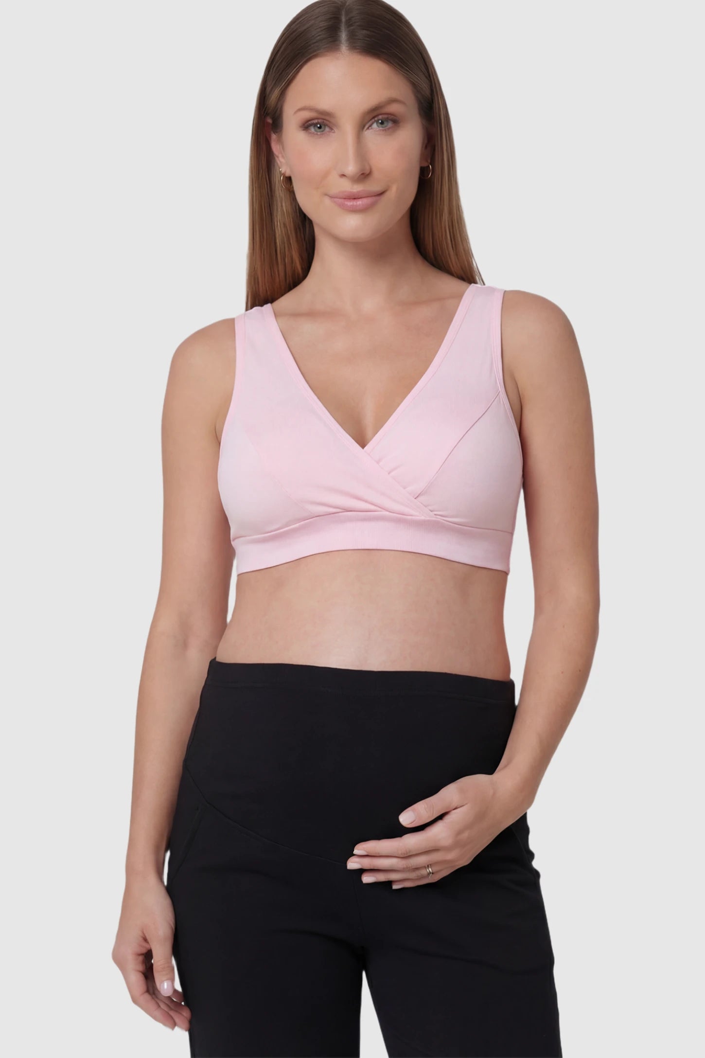 Soft Cotton Crossover Wireless Pull-On Maternity Nursing Bra in Pink featuring a wrap-front design on a pregnant model.