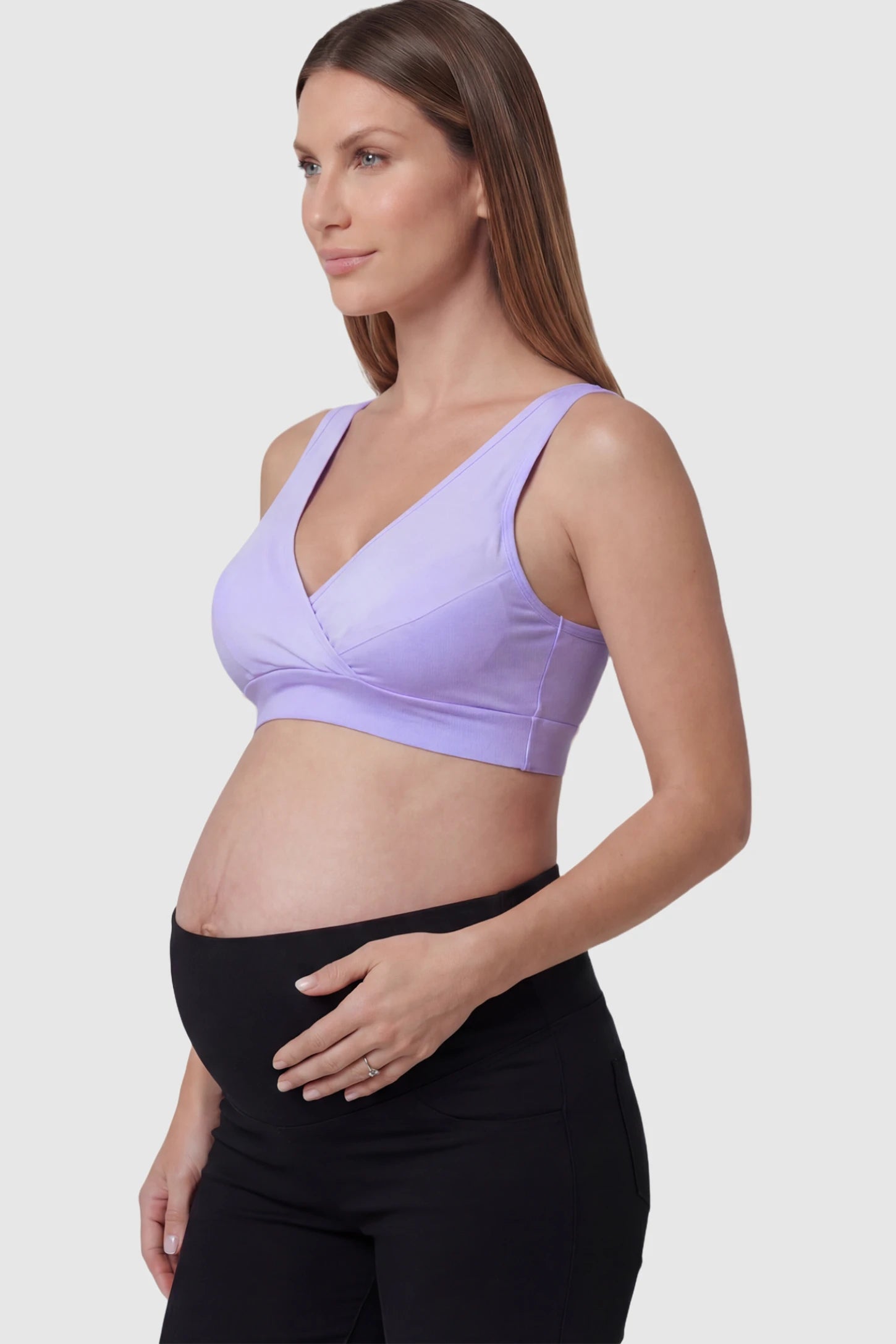 Soft Cotton Crossover Wireless Maternity Nursing Bra Soft Cotton Crossover Wireless Pull-On Maternity Nursing Bra in Purple featuring a wrap-front design on a pregnant model.