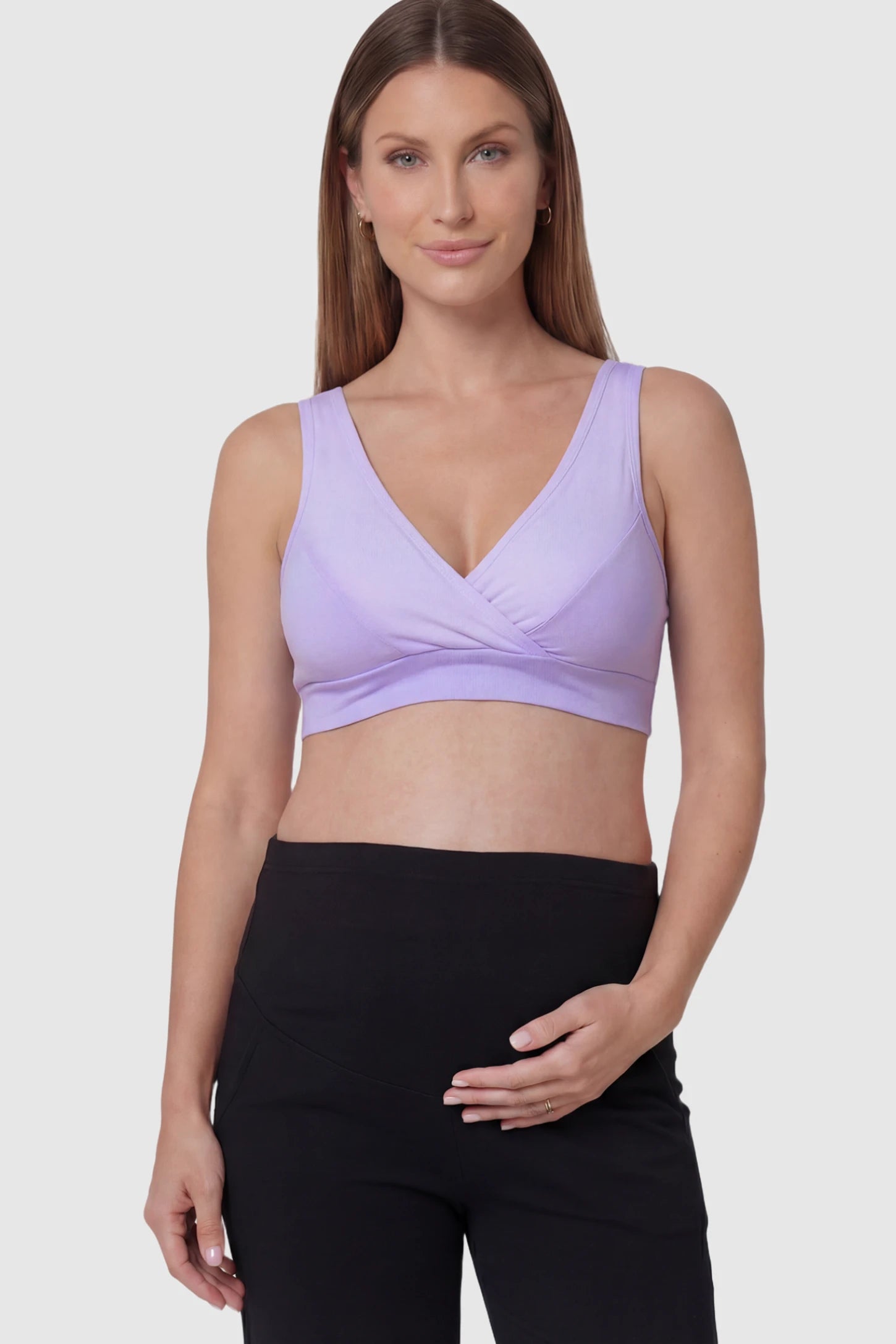 Soft Cotton Crossover Wireless Maternity Nursing Bra Soft Cotton Crossover Wireless Pull-On Maternity Nursing Bra in Purple featuring a wrap-front design on a pregnant model.