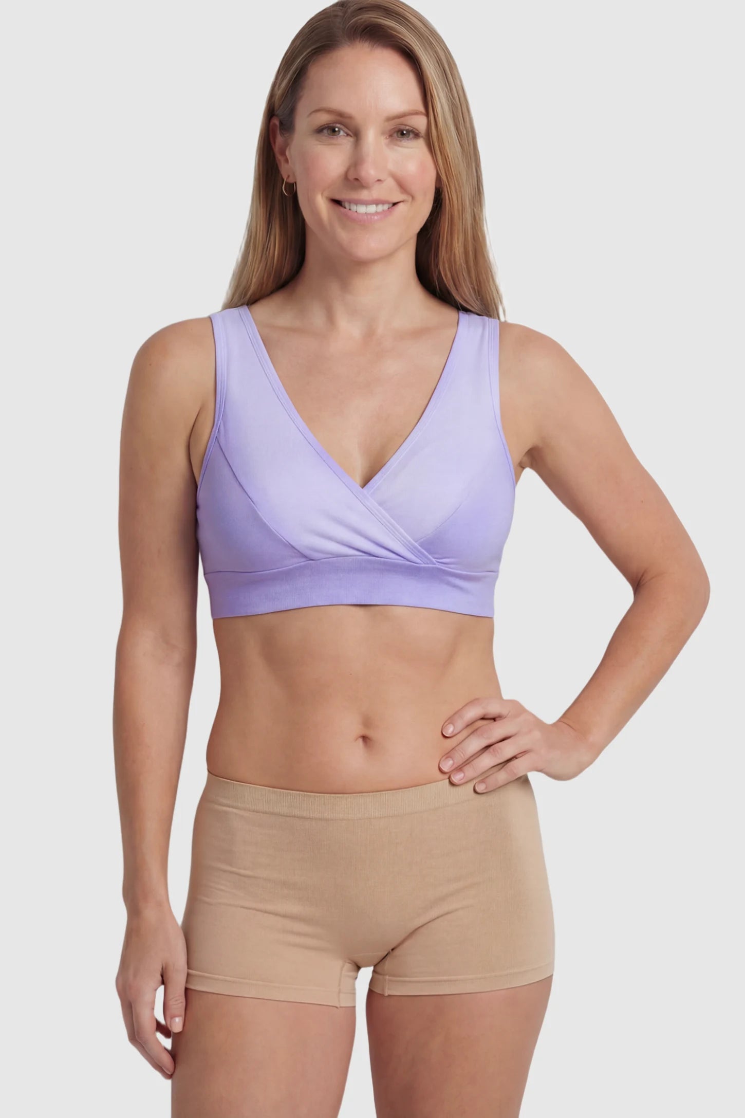 Soft Cotton Crossover Wireless Maternity Nursing Bra Soft Cotton Crossover Wireless Pull-On Maternity Nursing Bra in Purple featuring a wrap-front design on a postpartum model.