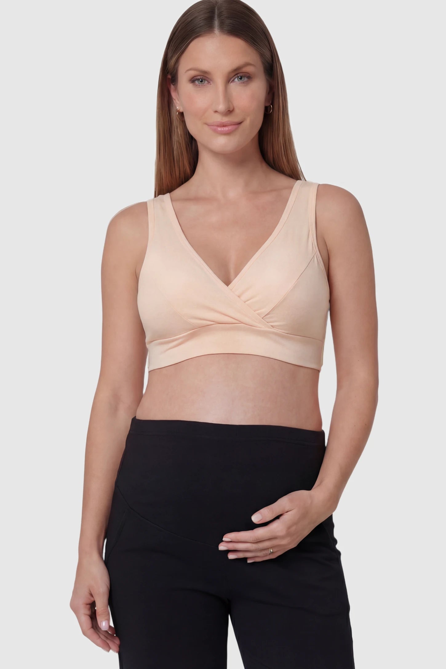 Soft Cotton Crossover Wireless Maternity Nursing Bra Soft Cotton Crossover Wireless Pull-On Maternity Nursing Bra in Shrimp Color featuring a wrap-front design on a pregnant model.