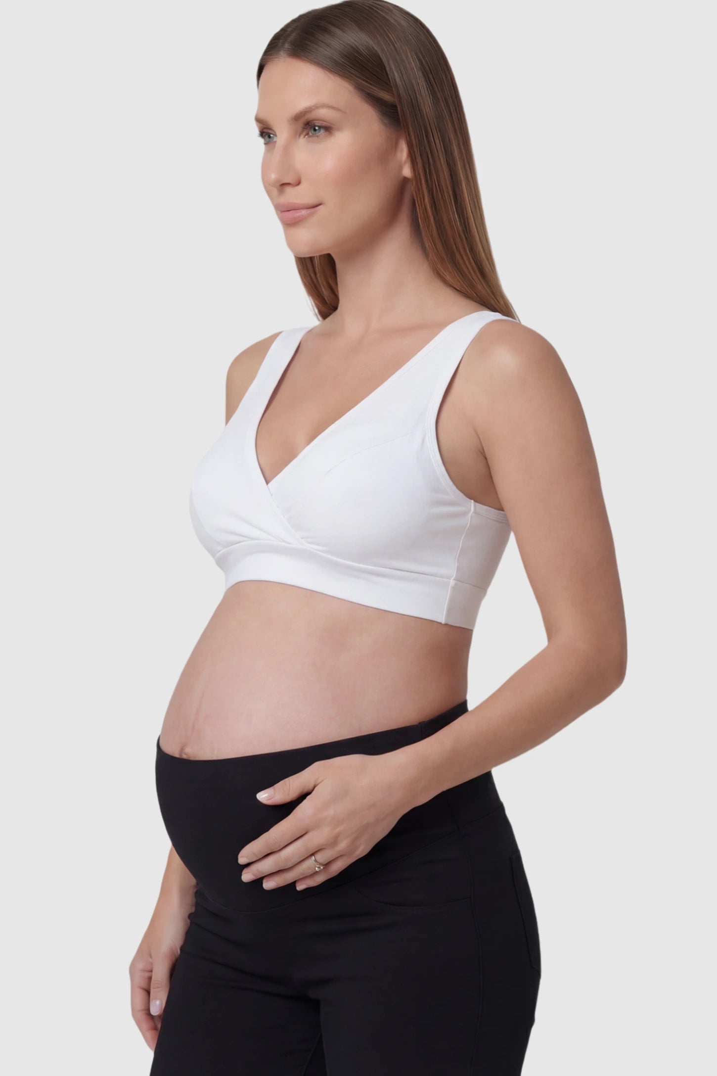 Soft Cotton Crossover Wireless Maternity Nursing Bra Soft Cotton Crossover Wireless Pull-On Maternity Nursing Bra in White featuring a wrap-front design on a pregnant model.