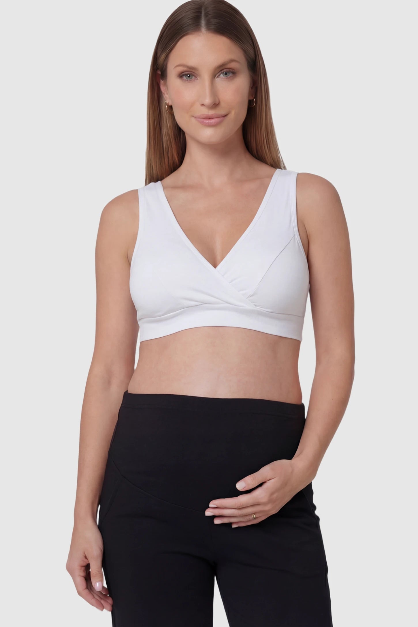 Soft Cotton Crossover Wireless Maternity Nursing Bra Soft Cotton Crossover Wireless Pull-On Maternity Nursing Bra in White featuring a wrap-front design on a pregnant model.