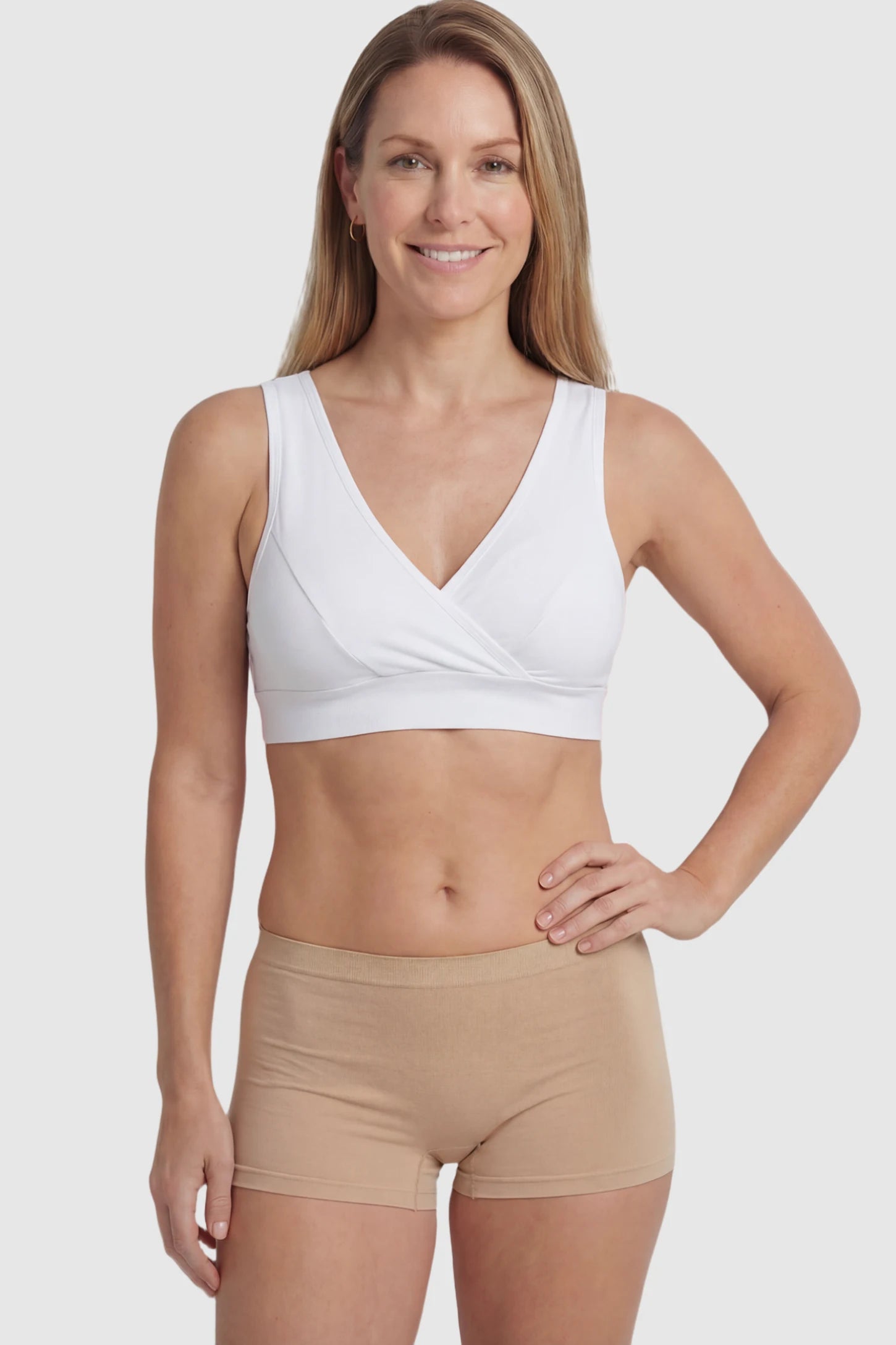 Soft Cotton Crossover Wireless Maternity Nursing Bra Soft Cotton Crossover Wireless Pull-On Maternity Nursing Bra in White featuring a wrap-front design on a postpartum model.