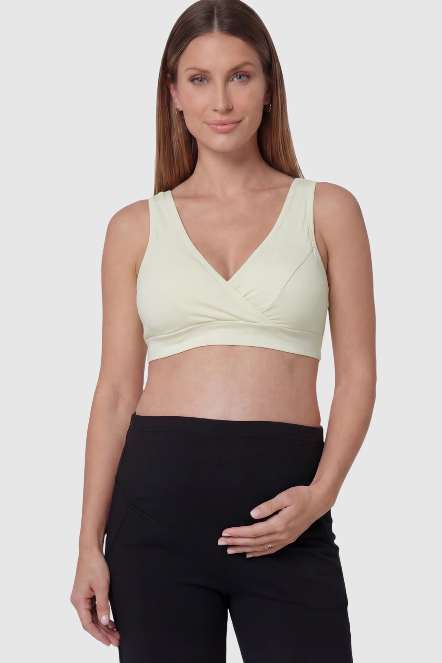 Soft Cotton Crossover Wireless Maternity Nursing Bra Soft Cotton Crossover Wireless Pull-On Maternity Nursing Bra in Yellow featuring a wrap-front design on a pregnant model.