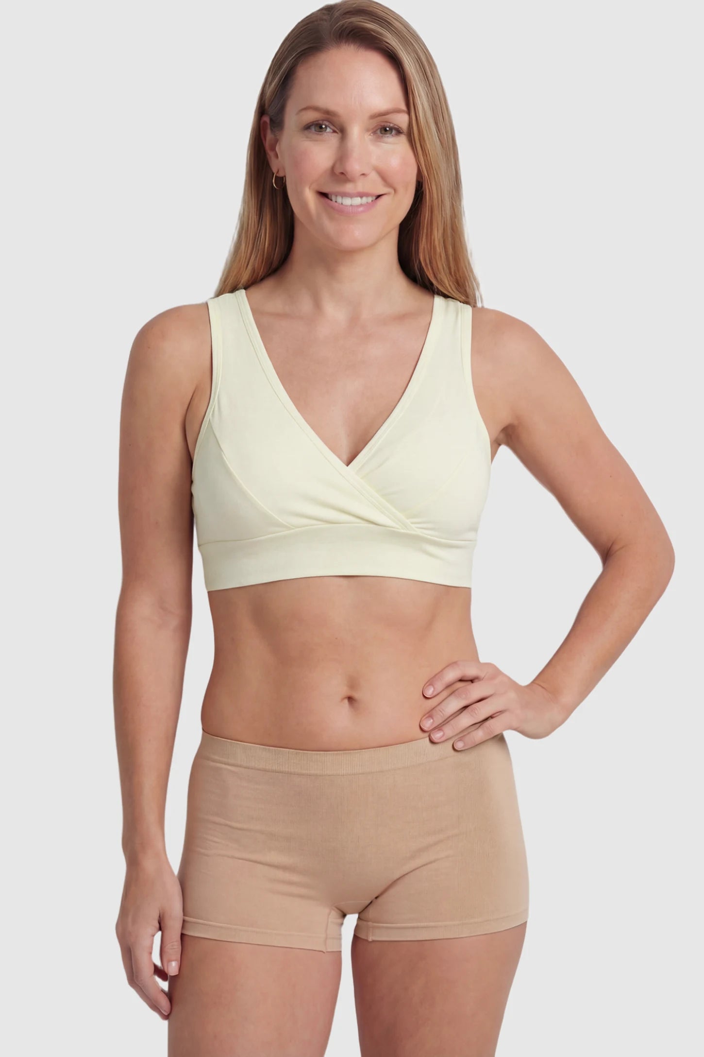 Soft Cotton Crossover Wireless Maternity Nursing Bra Soft Cotton Crossover Wireless Pull-On Maternity Nursing Bra in Yellow featuring a wrap-front design on a postpartum model.