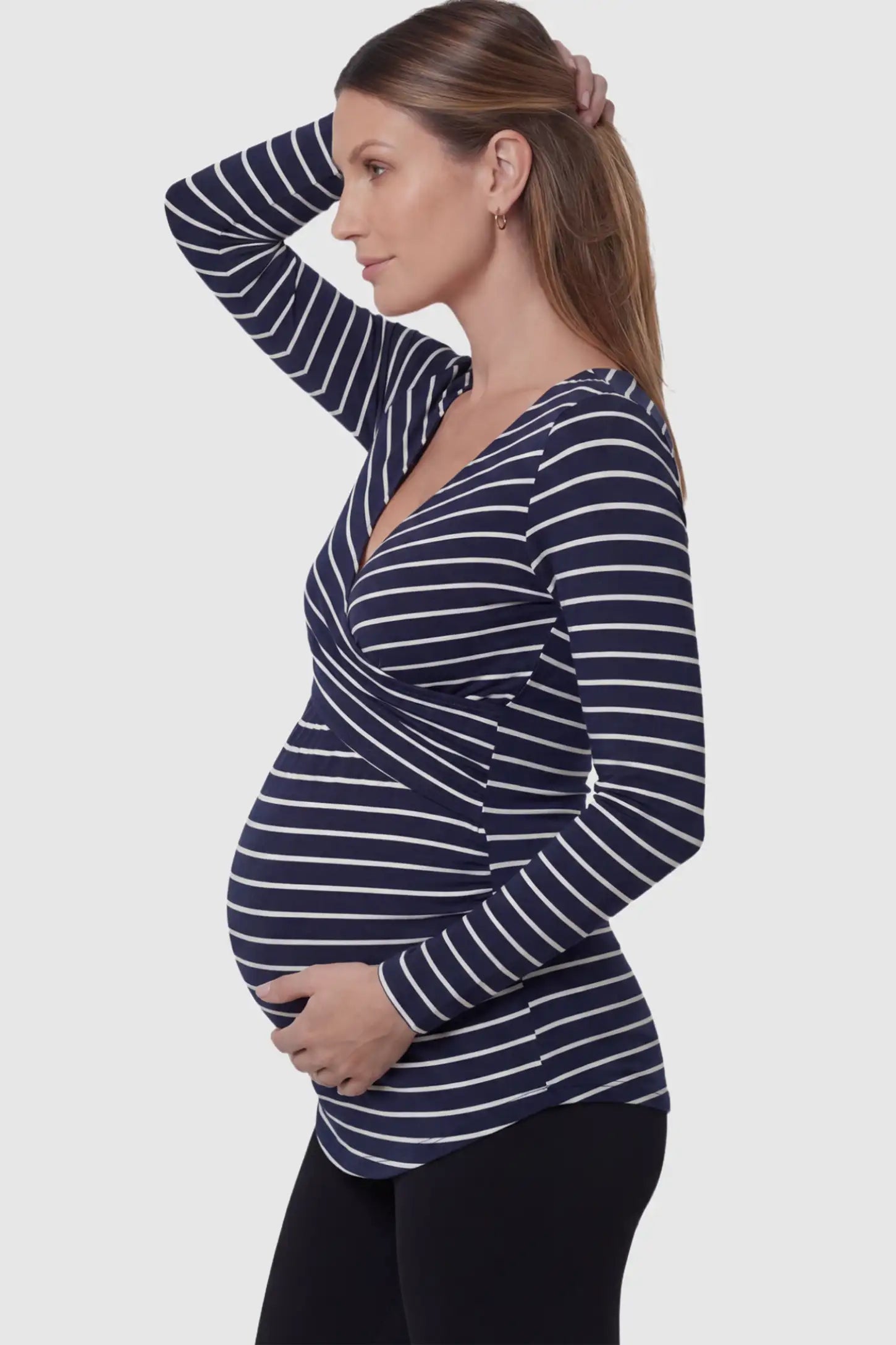 Striped Wrap Front Nursing Top in navy blue with crossover neckline on a pregnant model.
