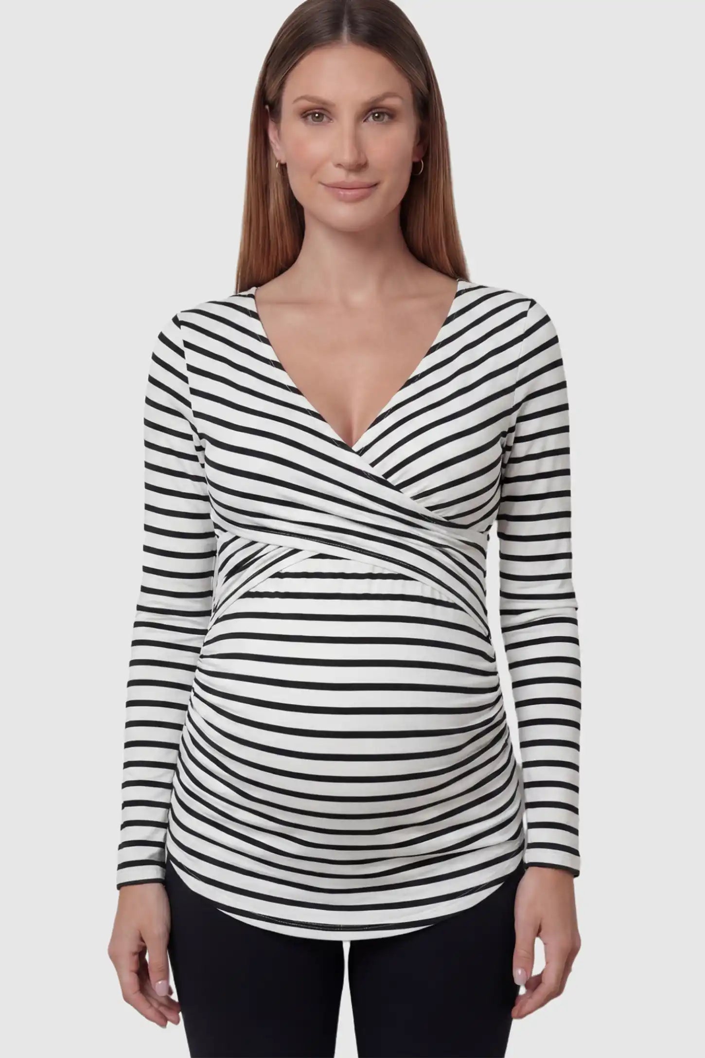 Striped Wrap Front Maternity & Nursing Top Striped Wrap Front Nursing Top in White with crossover neckline on a pregnant model.