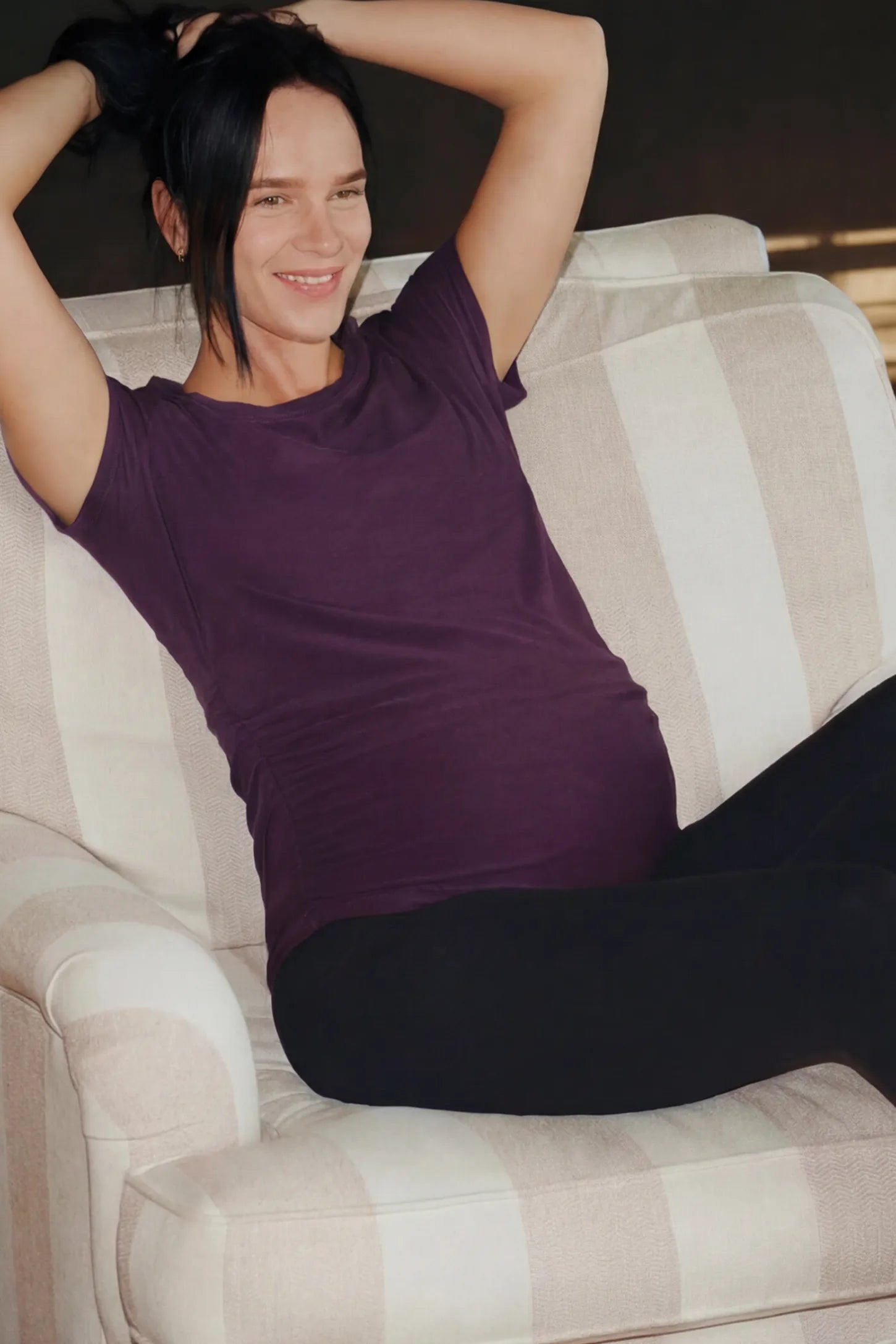 Full Panel Skinny Maternity Pants Full Panel Skinny Maternity Pants in black featuring high stretch viscose and cotton blend on a pregnant woman in a room setting.