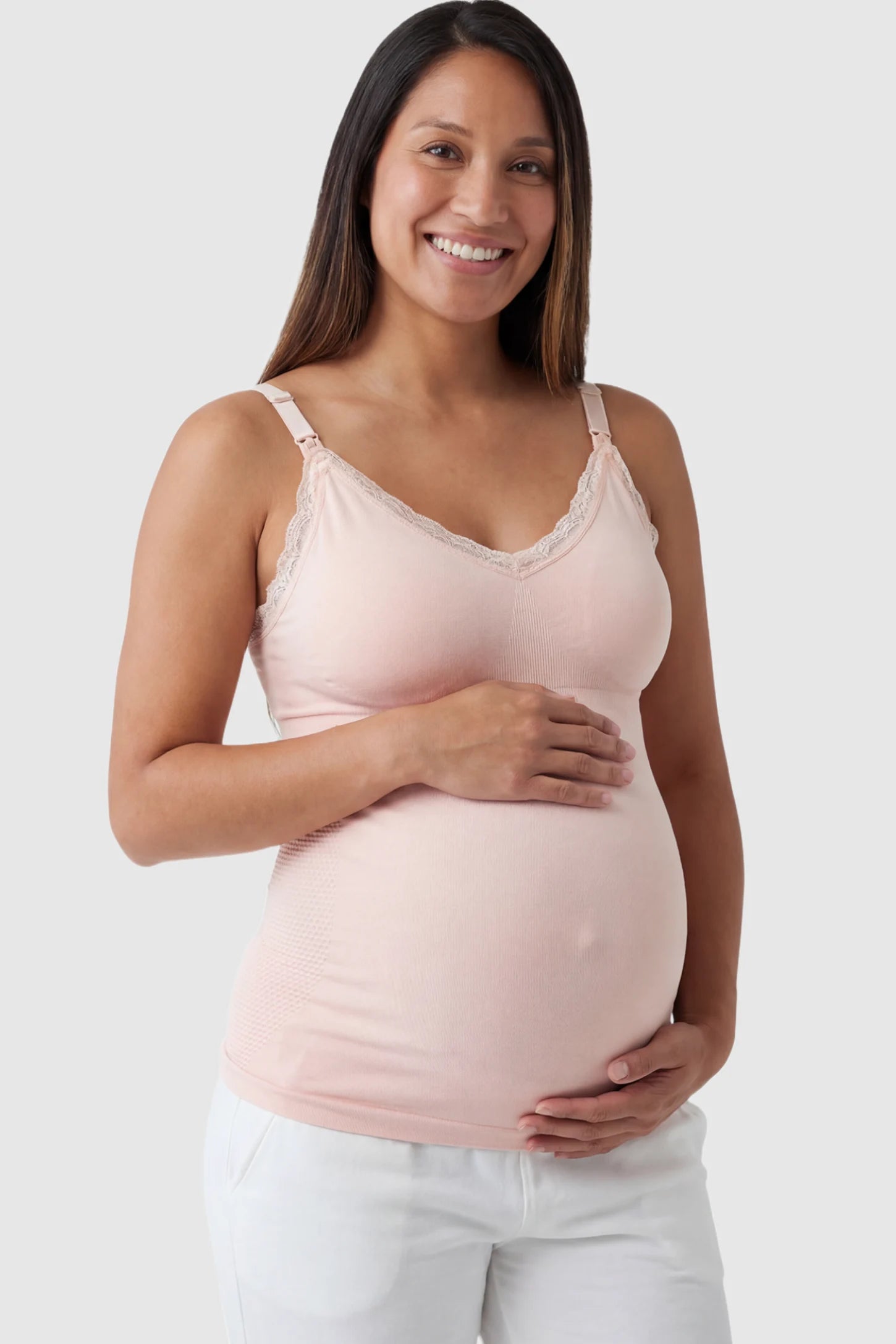 Lace Trim Wire Free Maternity Nursing Camisole in light pink offering one-handed nursing access on a pregnant model.