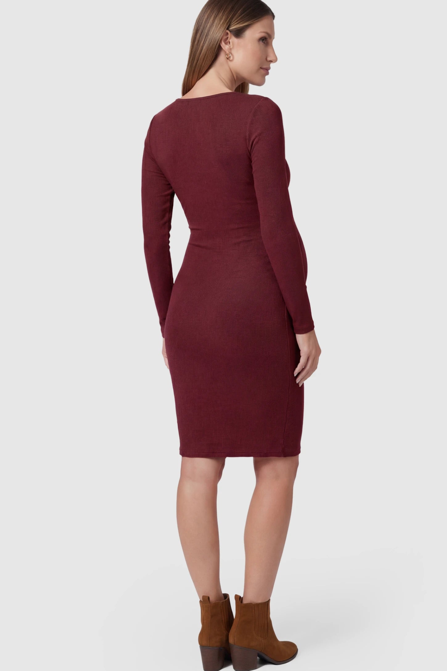 Ribbed Twist Front Long Sleeve Bodycon Maternity Short Dress Twist-Front Long Sleeve Ribbed Maternity Mini Dress in Red featuring a textured knit finish on a pregnant model.
