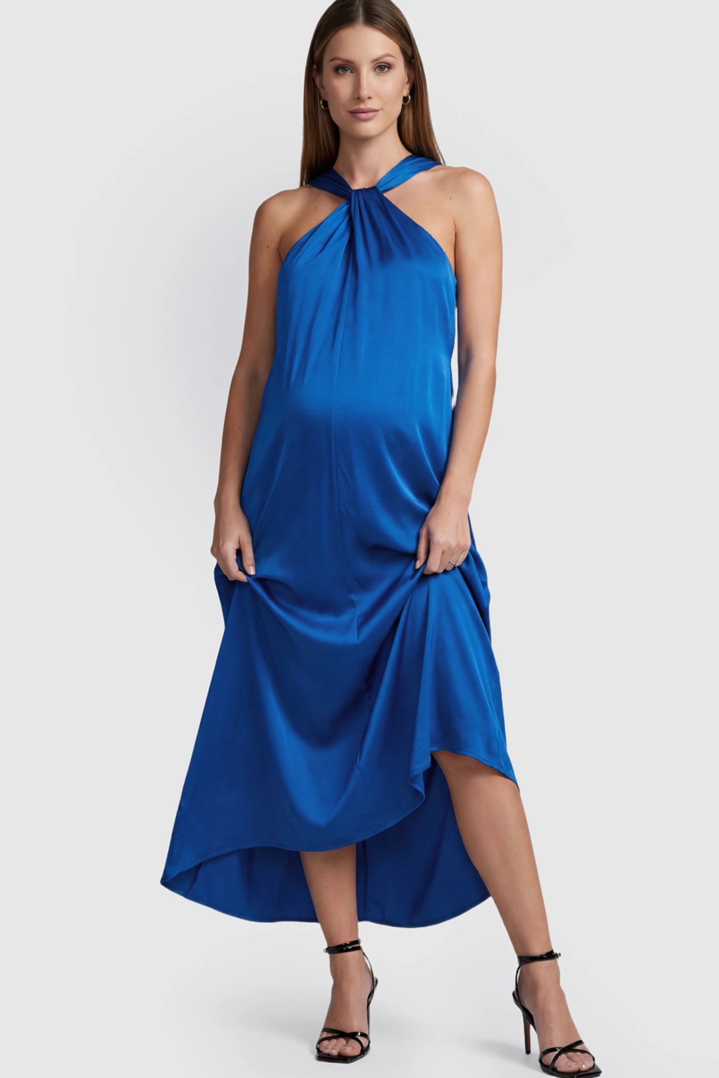 Solid Satin Tie-Waist Halter Maxi Maternity Dress in Blue on a pregnant model.