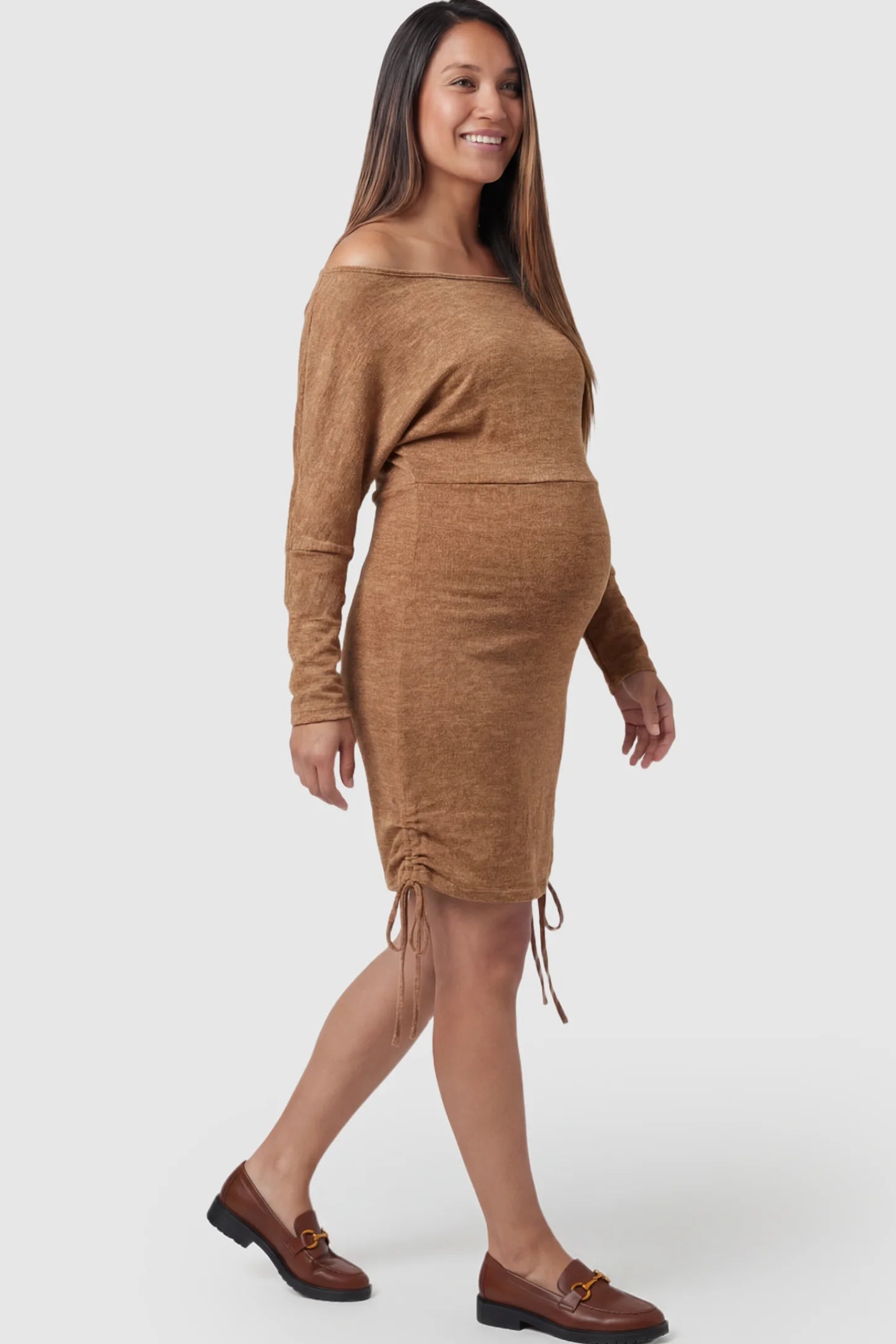 Ruched Side Maternity Bodycon Dress in Brown featuring an off-the-shoulder neckline and drawstring detail on a pregnant model.