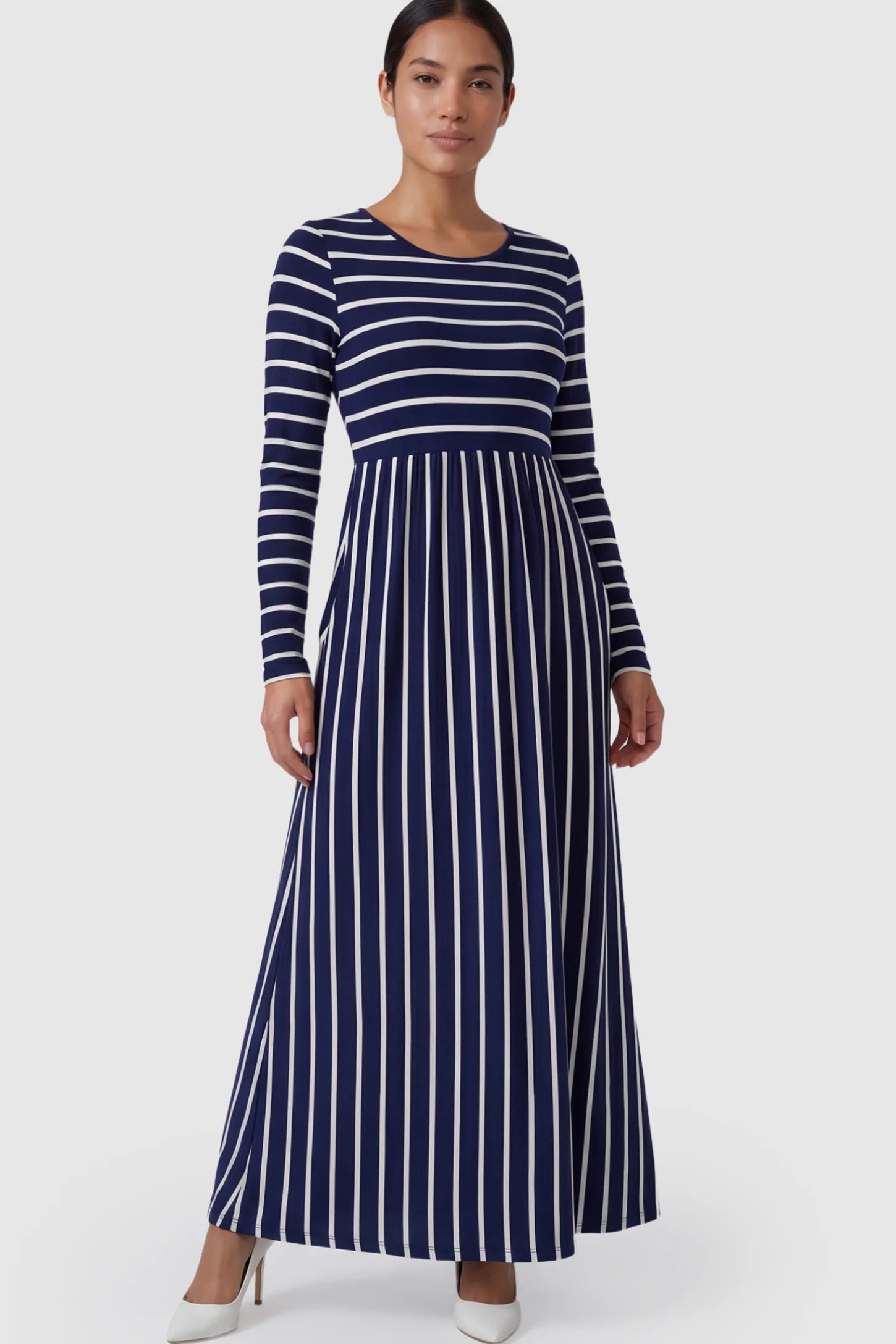 Striped Long Sleeve Maternity Maxi Dress Stretch Jersey Mixed-Stripe Maternity Maxi Dress in dark blue and White featuring an empire waist on a postpartum model.