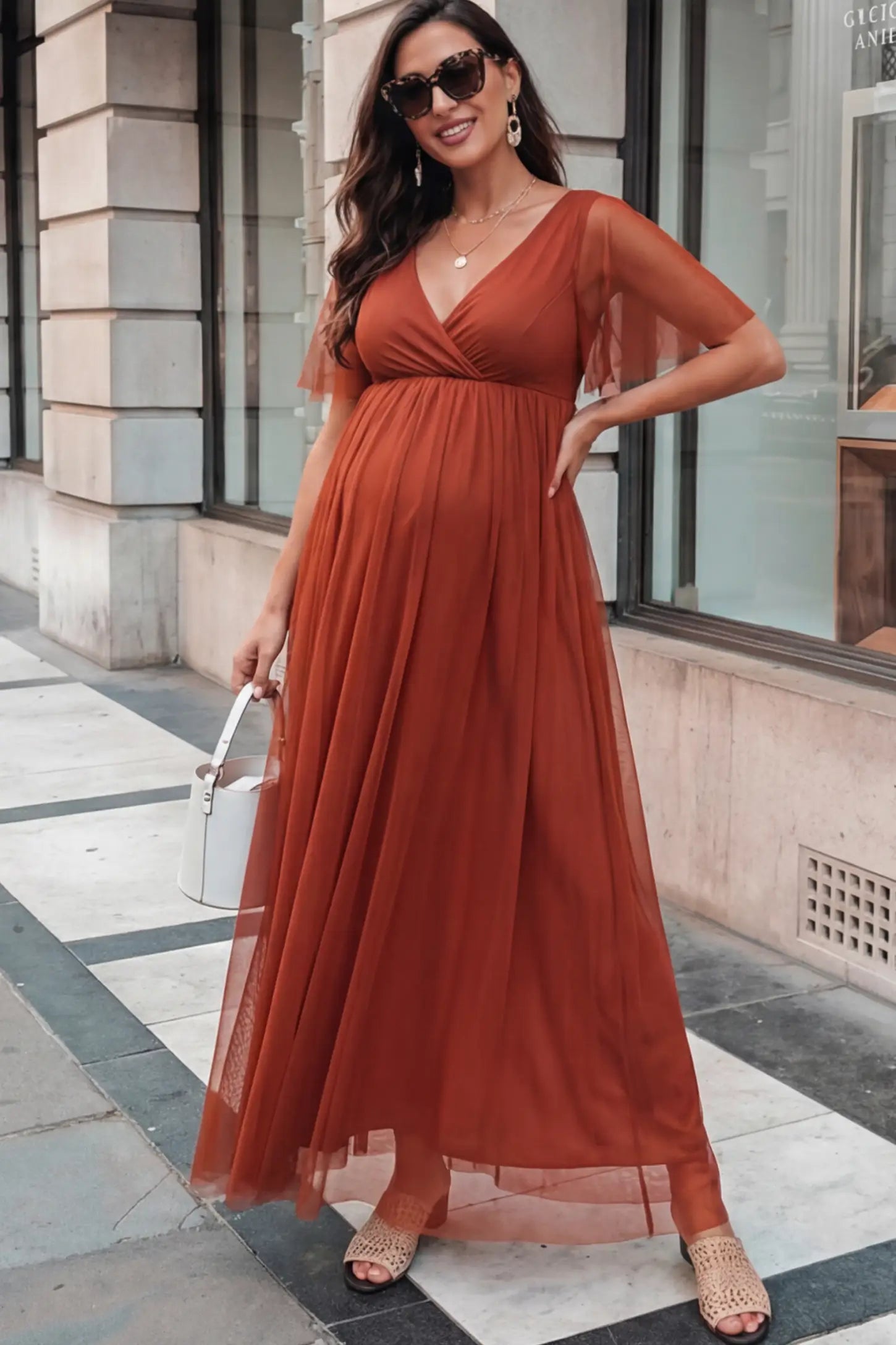 Chiffon Flutter Sleeve V-Neck Maternity Maxi Dress in Rust featuring a mesh overlay on a pregnant model.
